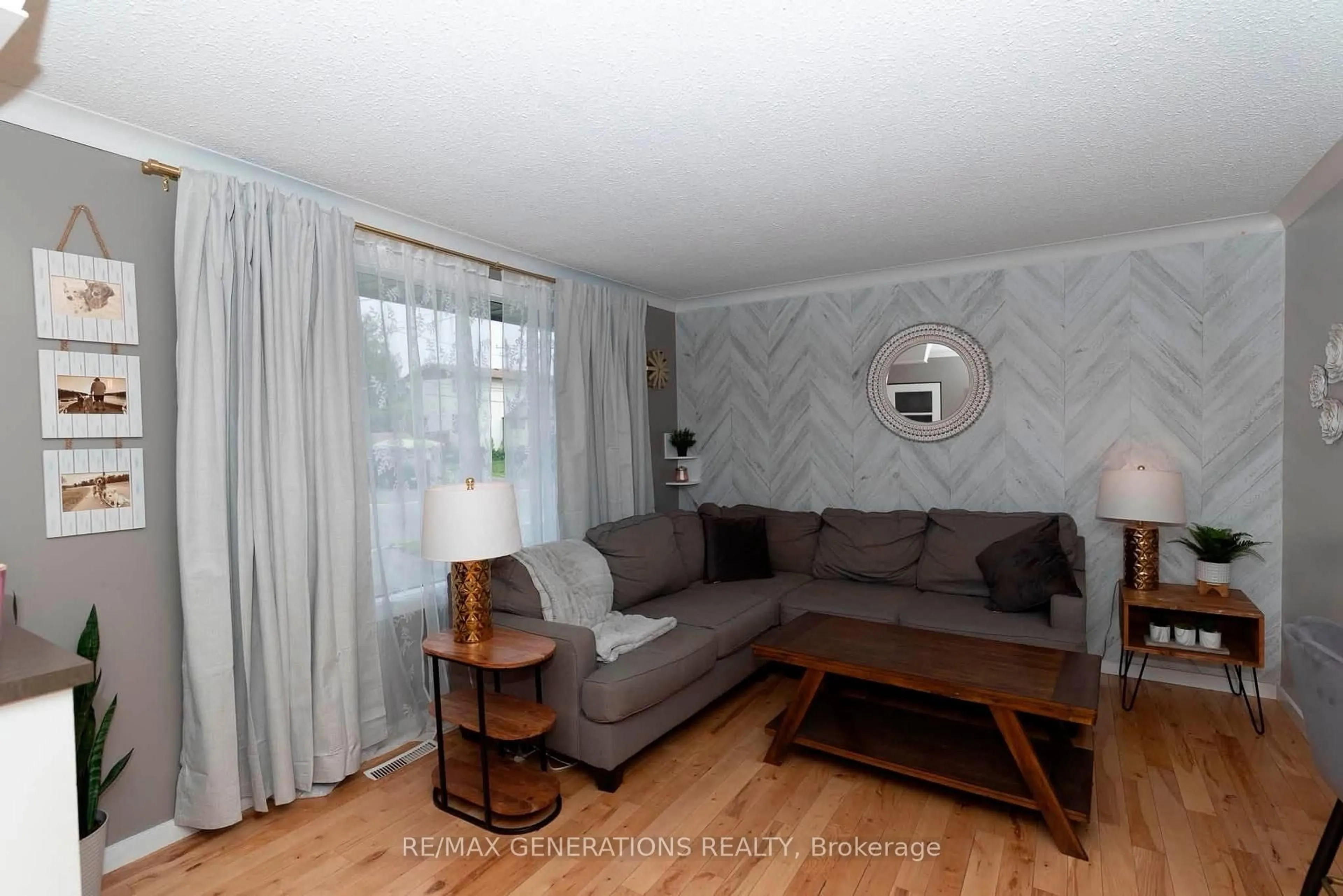 Living room with furniture, wood/laminate floor for 473 Tupper St, Thunder Bay Ontario P7A 3Z5