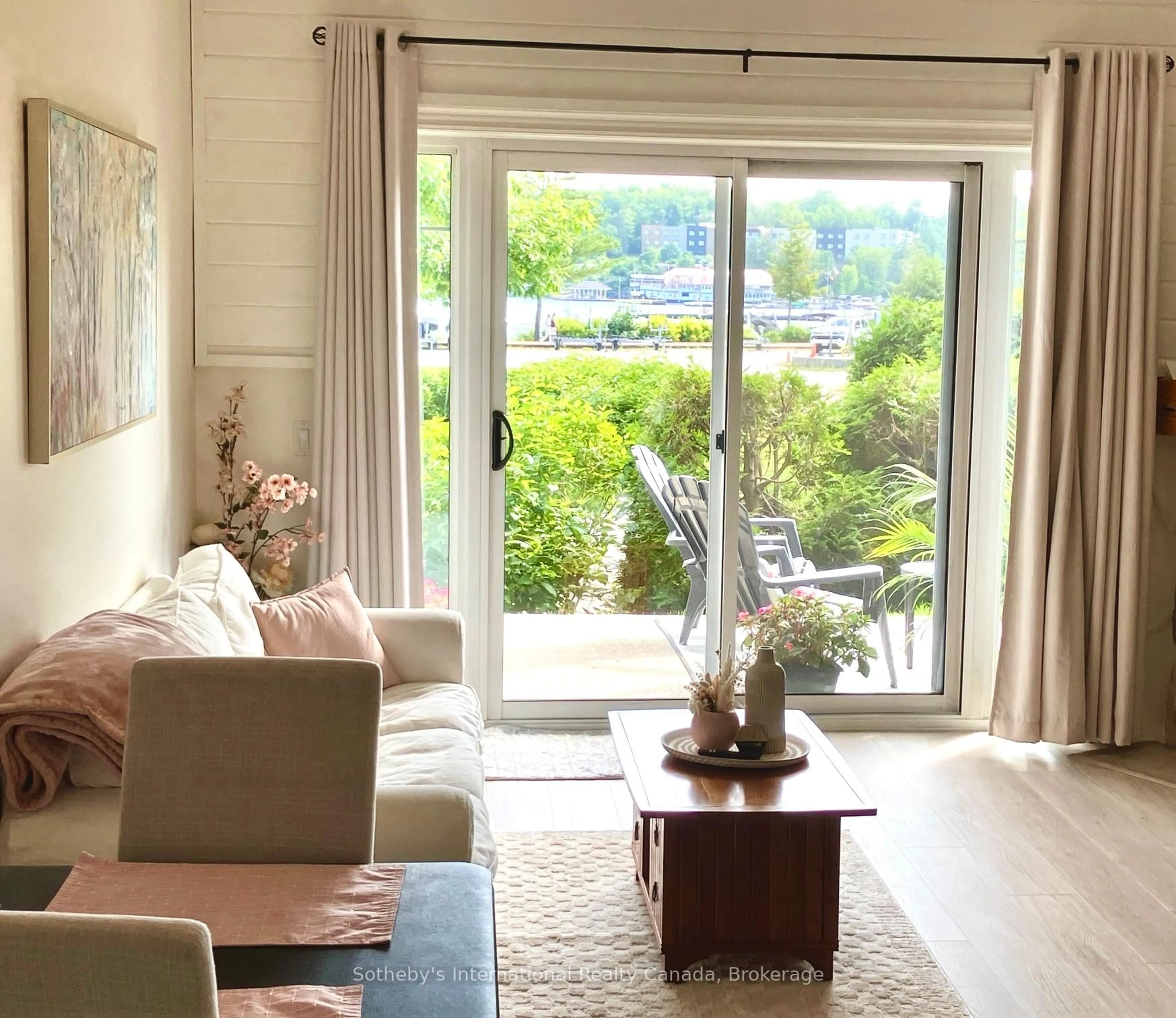 Living room with furniture, wood/laminate floor for 110 Steamship Bay Rd #102, Gravenhurst Ontario P1P 1Z9