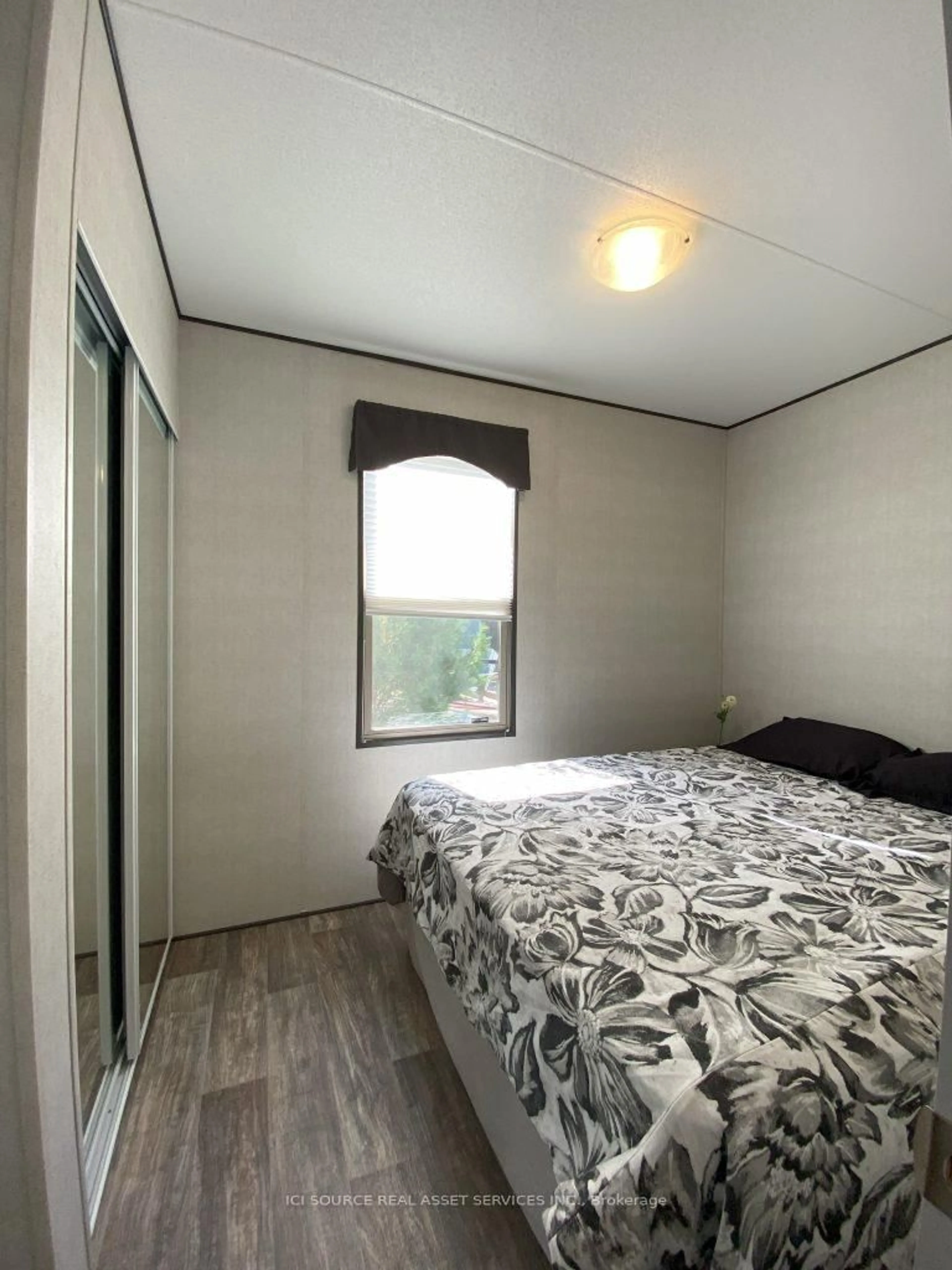 Bedroom with bed, wood/laminate floor for 1047 Bonnie Lake Camp Dr #WCW19, Bracebridge Ontario P1L 1W9