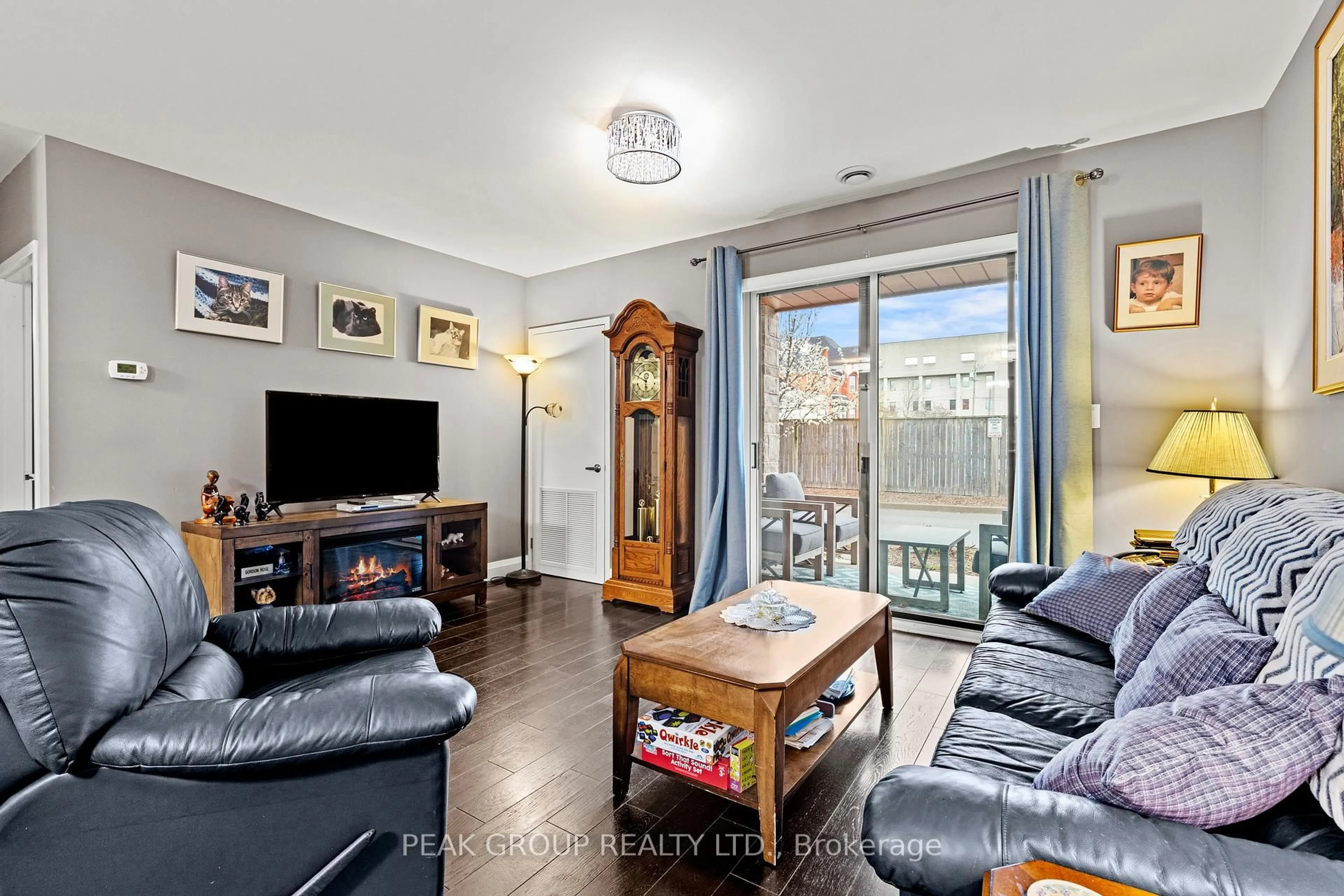 Living room with furniture, wood/laminate floor for 26 Wellington St #106, St. Catharines Ontario L2R 5P8