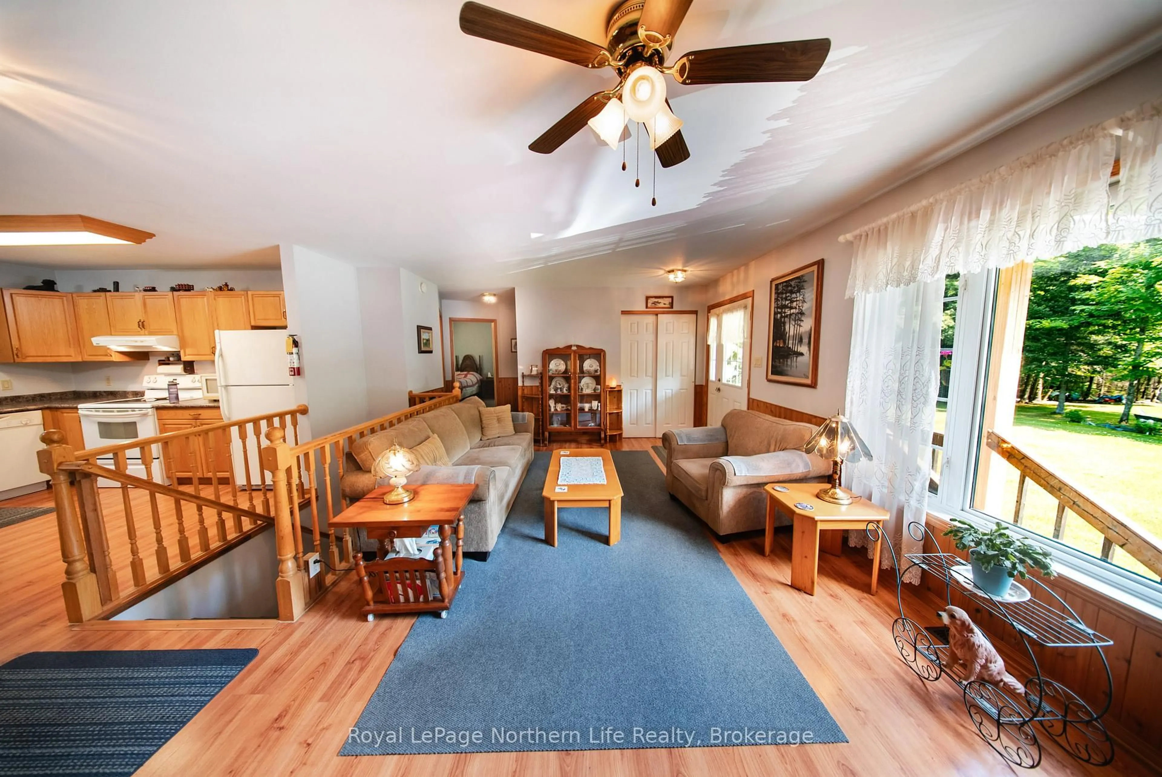 Living room with furniture, wood/laminate floor for 1025 Maple Rd, Chisholm Ontario P0H 1Z0