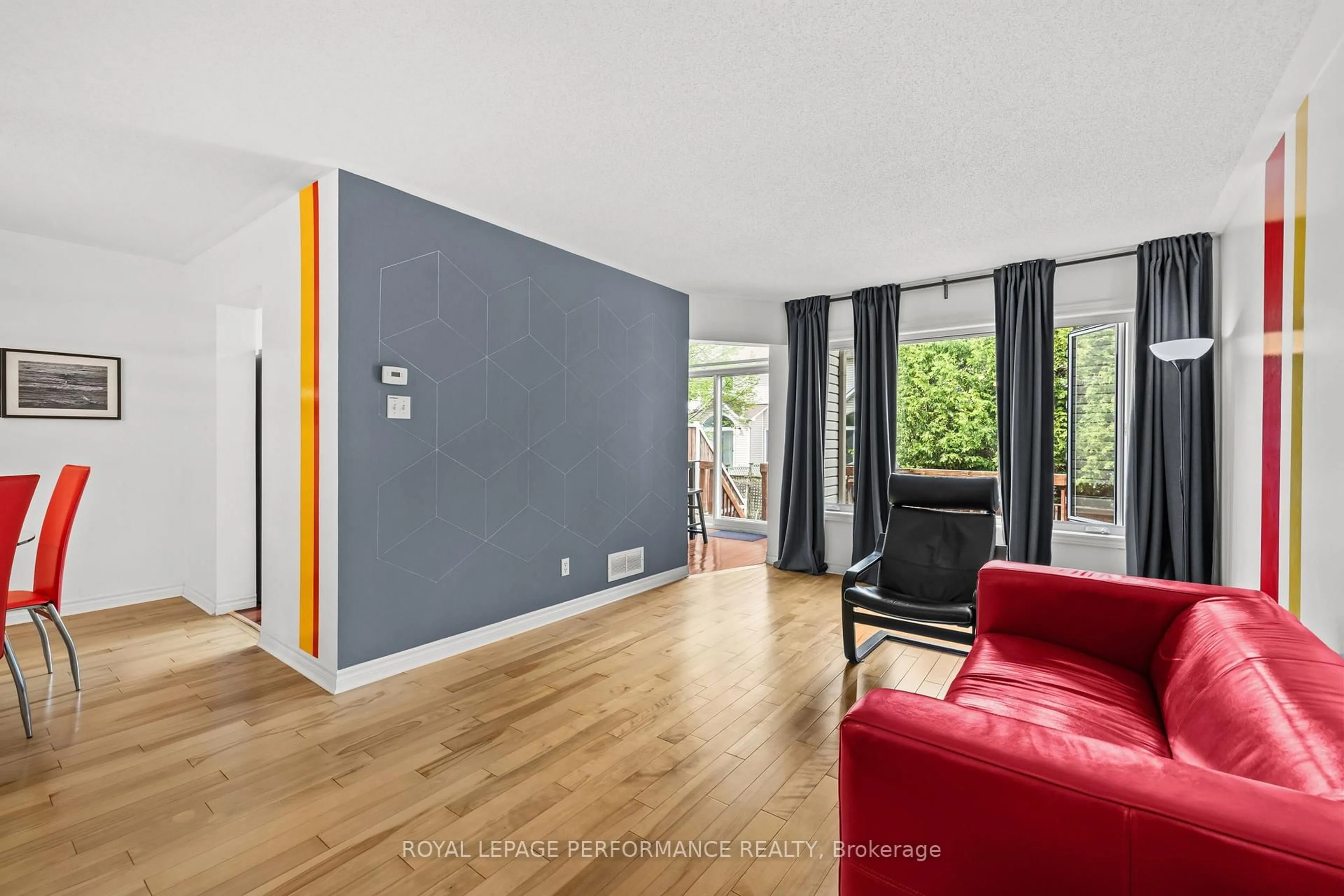 Living room with furniture, wood/laminate floor for 6420 Sablewood Pl, Ottawa Ontario K1C 7L7