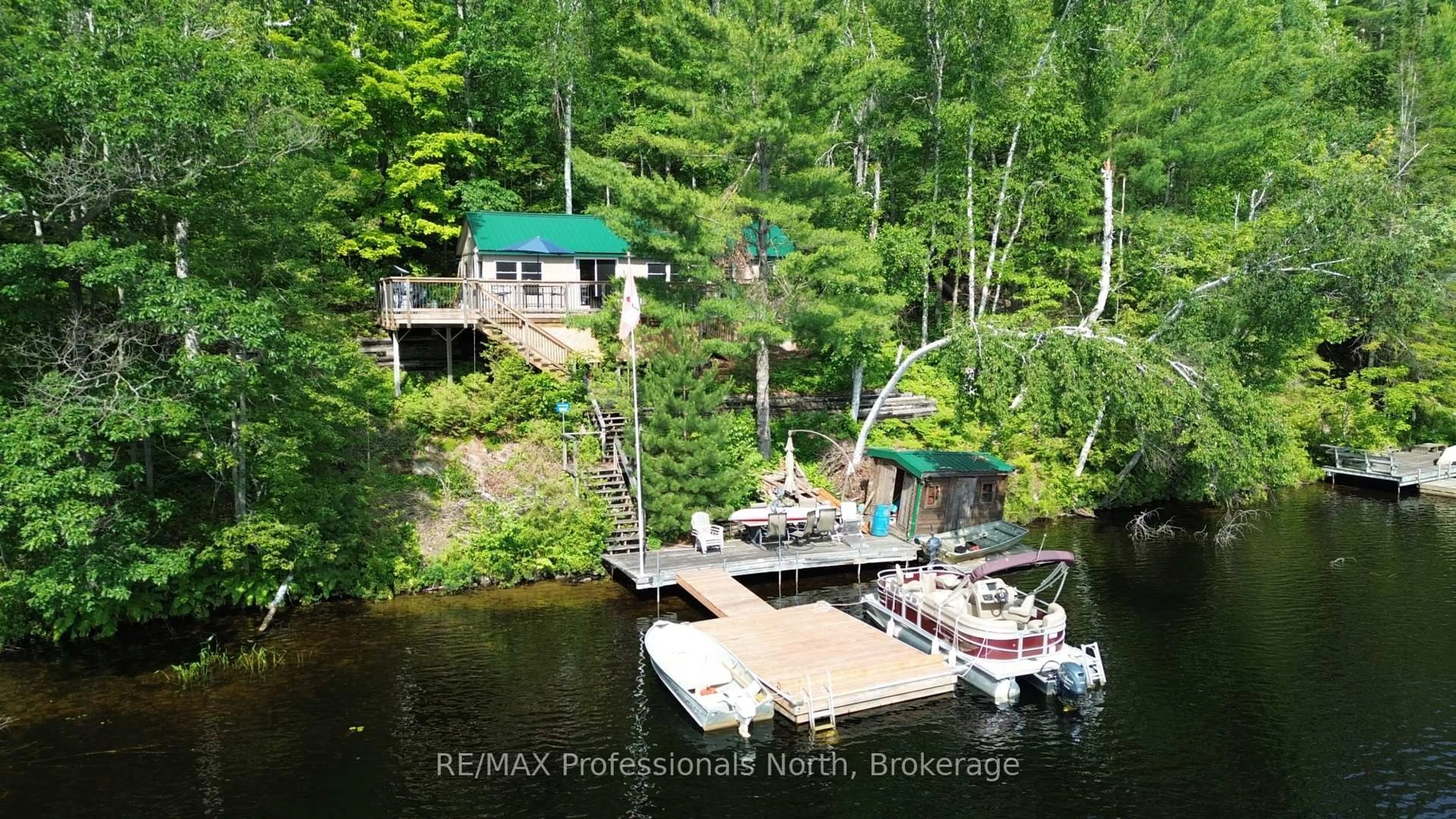 A pic from outside/outdoor area/front of a property/back of a property/a pic from drone, water/lake/river/ocean view for 10597 Black Lake WAO, Minden Hills Ontario K0M 2L0
