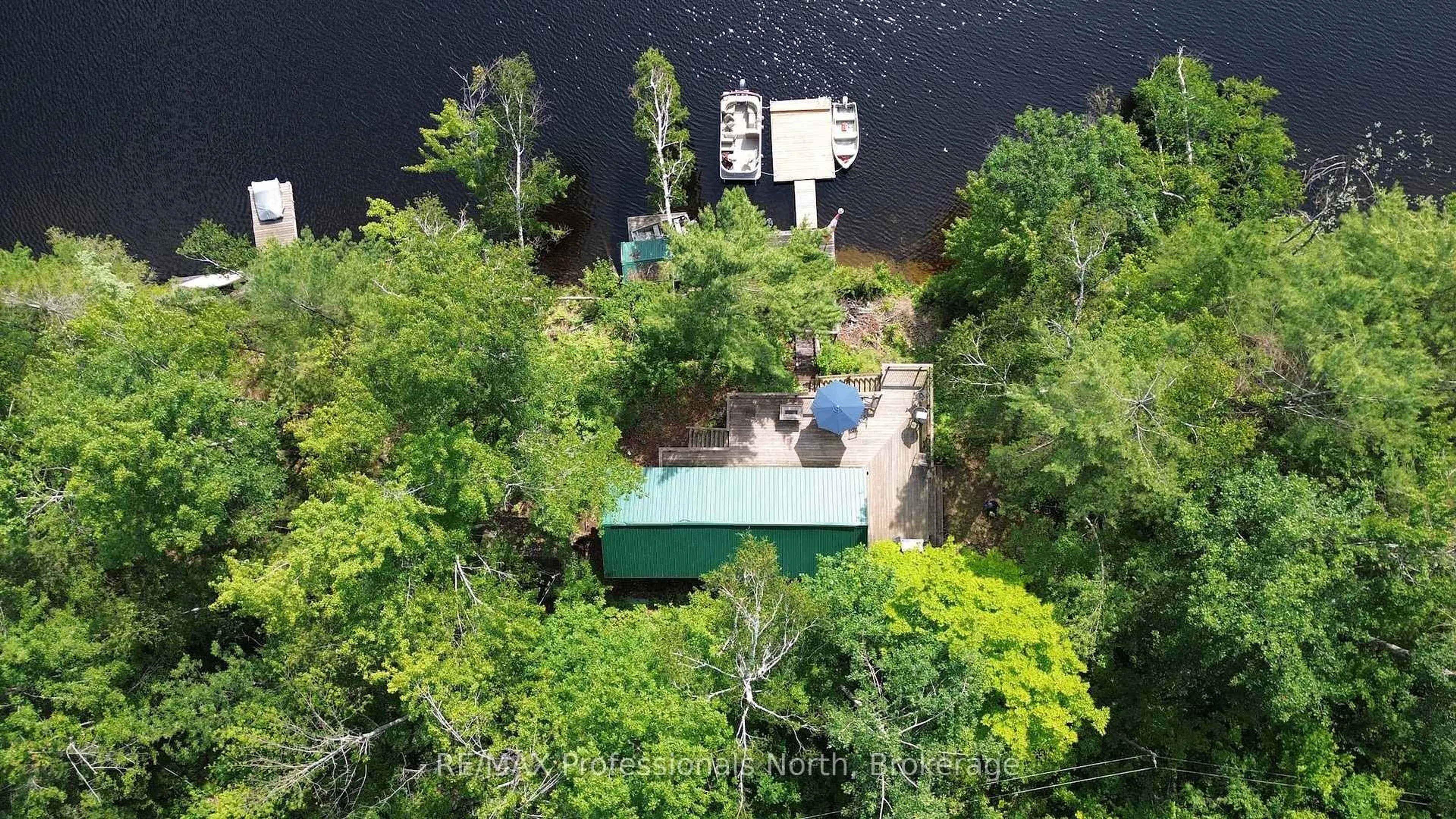 A pic from outside/outdoor area/front of a property/back of a property/a pic from drone, water/lake/river/ocean view for 10597 Black Lake WAO, Minden Hills Ontario K0M 2L0