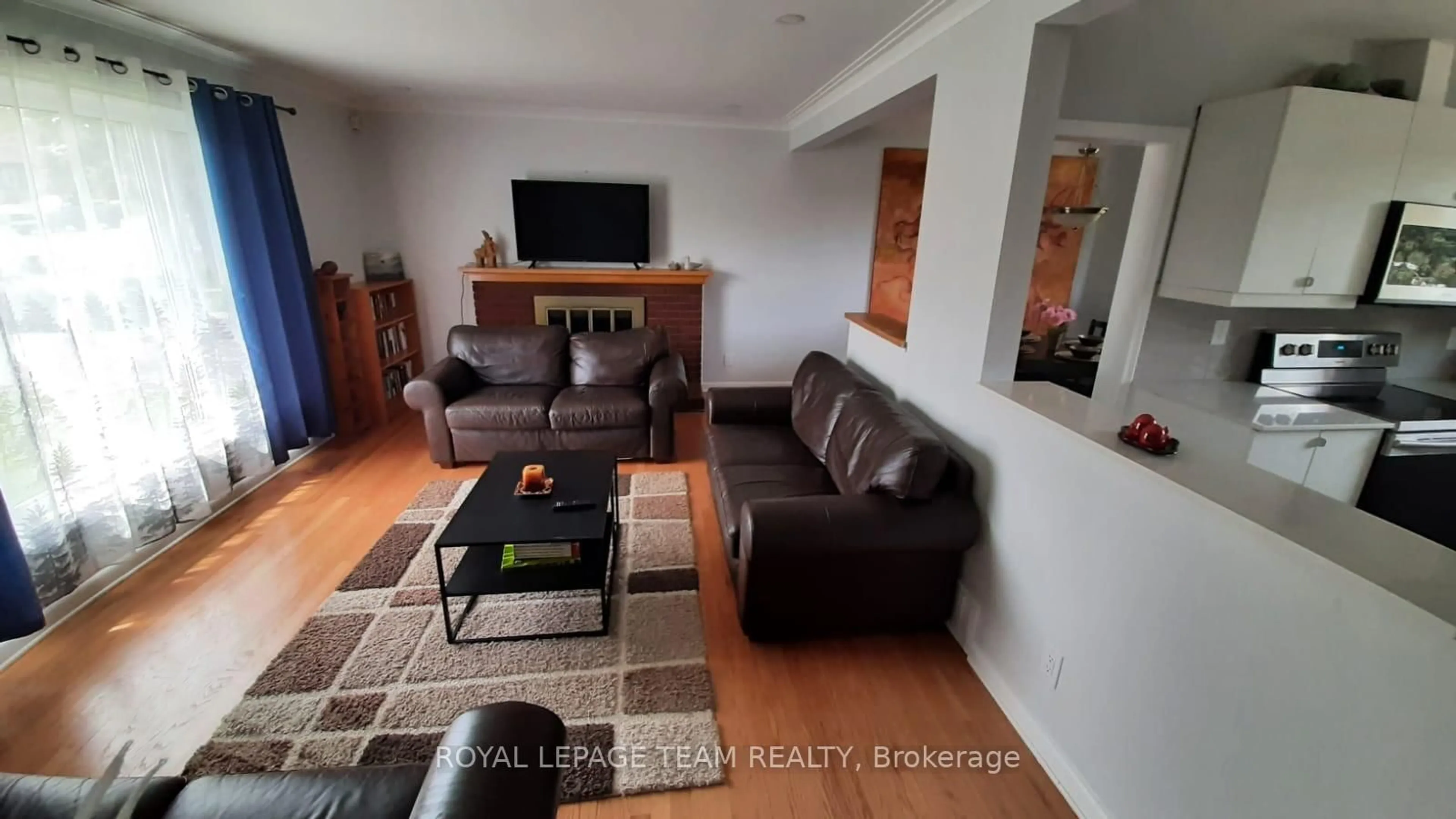 Living room with furniture, wood/laminate floor for 1015 Pinecrest Rd, Ottawa Ontario K2B 6B6
