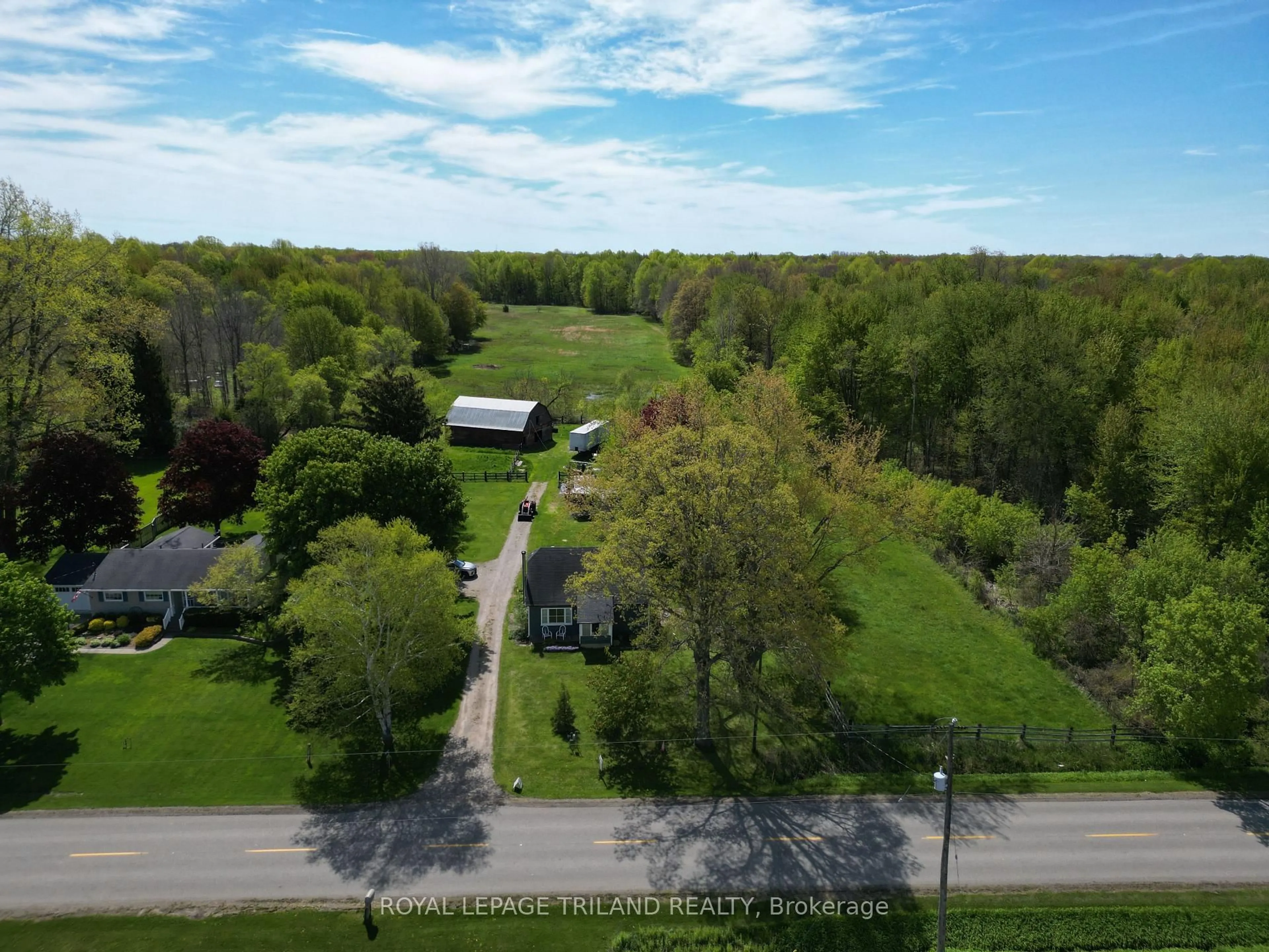 A pic from outside/outdoor area/front of a property/back of a property/a pic from drone, forest/trees view for 24909 Queens Line, West Elgin Ontario N0L 2P0