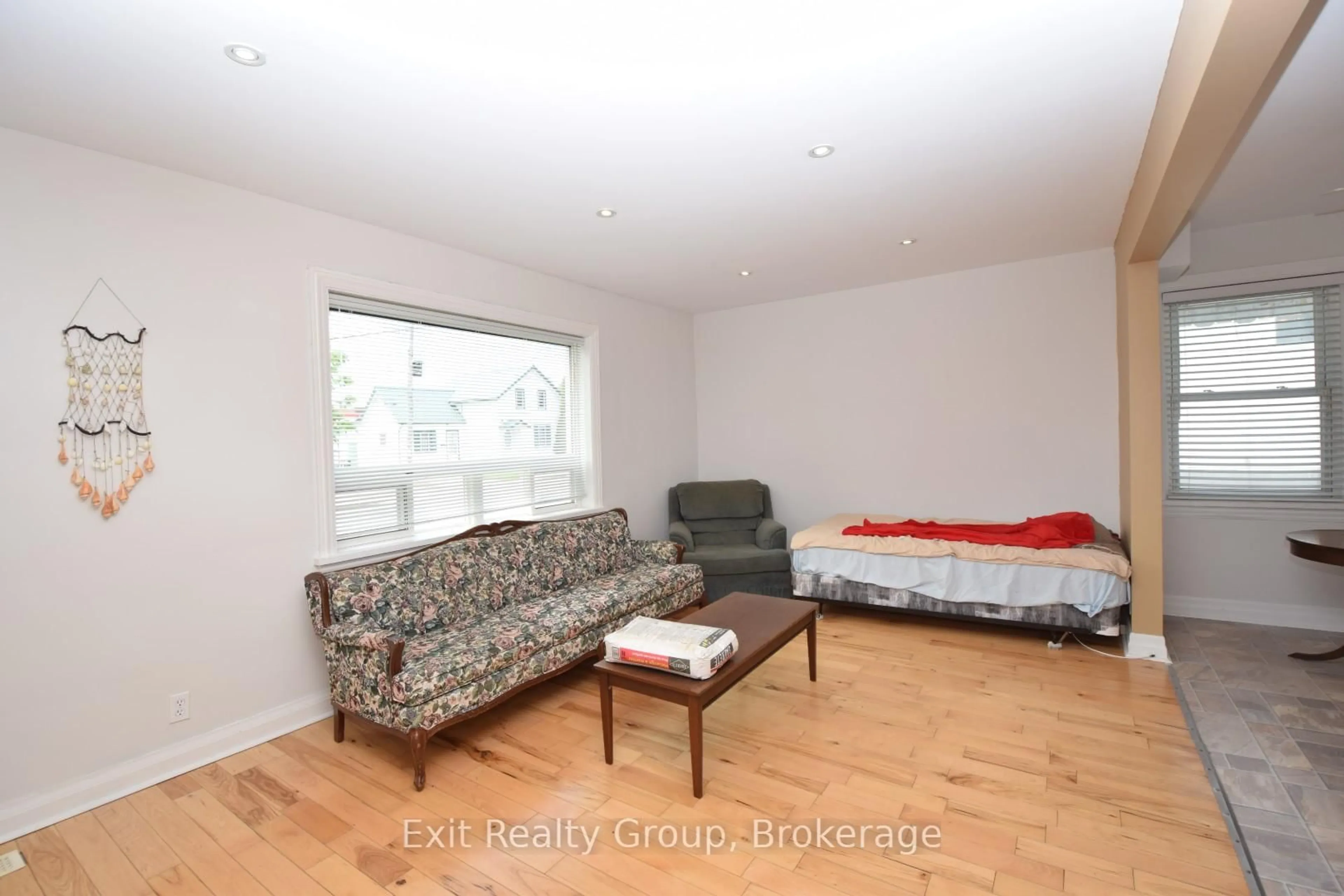 Living room with furniture, wood/laminate floor for 13 Flindall St, Quinte West Ontario K8V 3C9