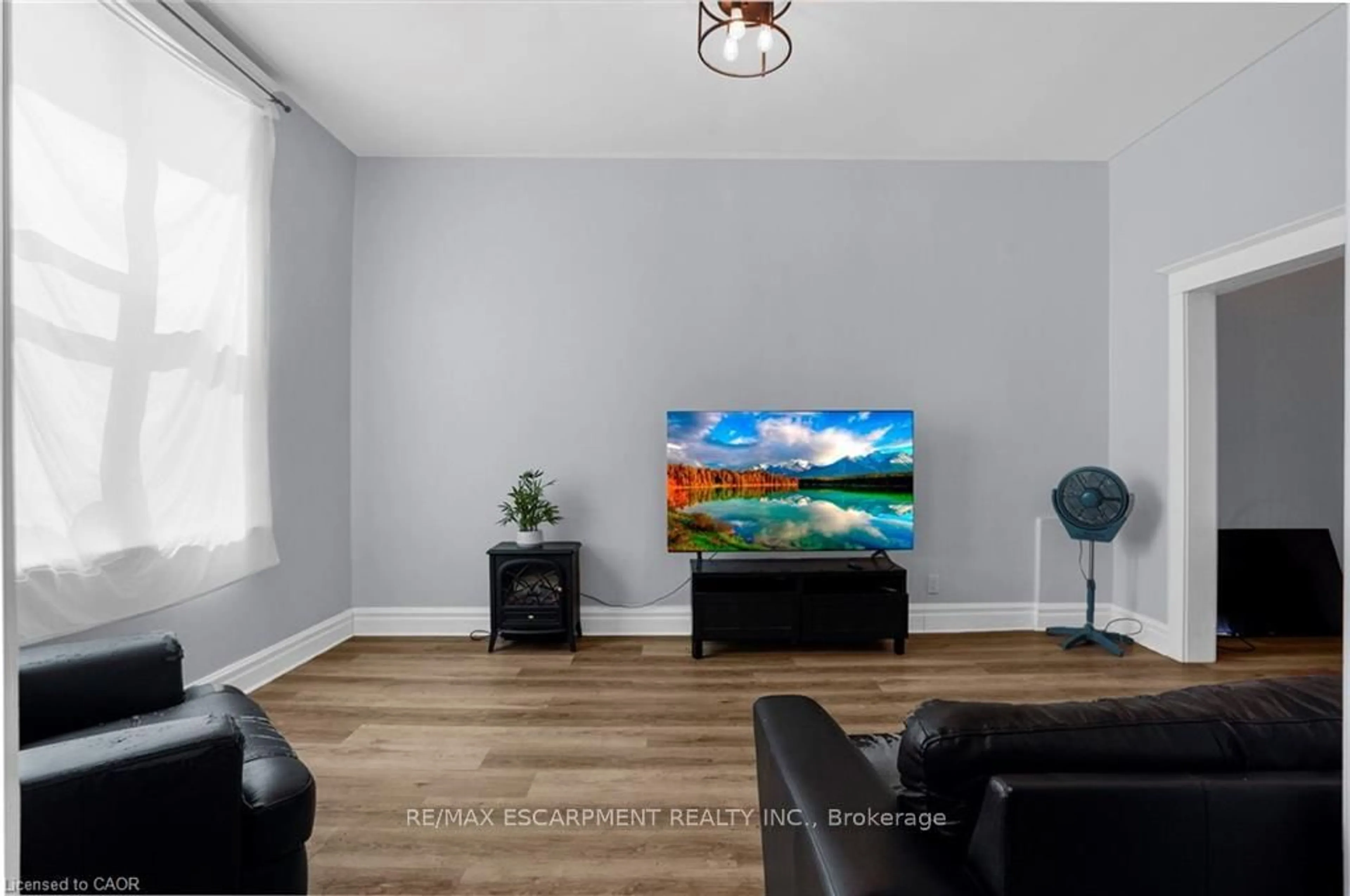 Living room with furniture, wood/laminate floor for 11 Wright Ave, Hamilton Ontario L8L 2T5