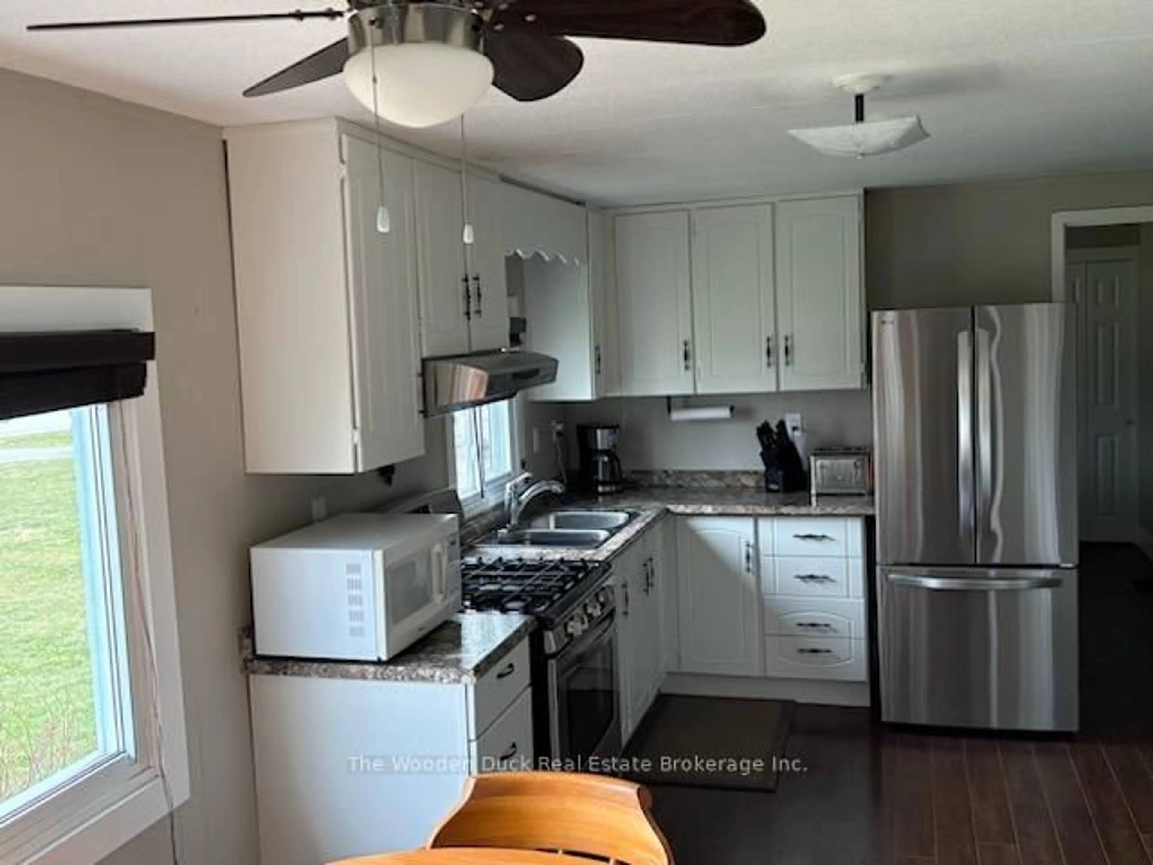 Open concept kitchen, wood/laminate floor for 1314 County RD 96 Rd, Wolfe Island Ontario K0H 2Y0