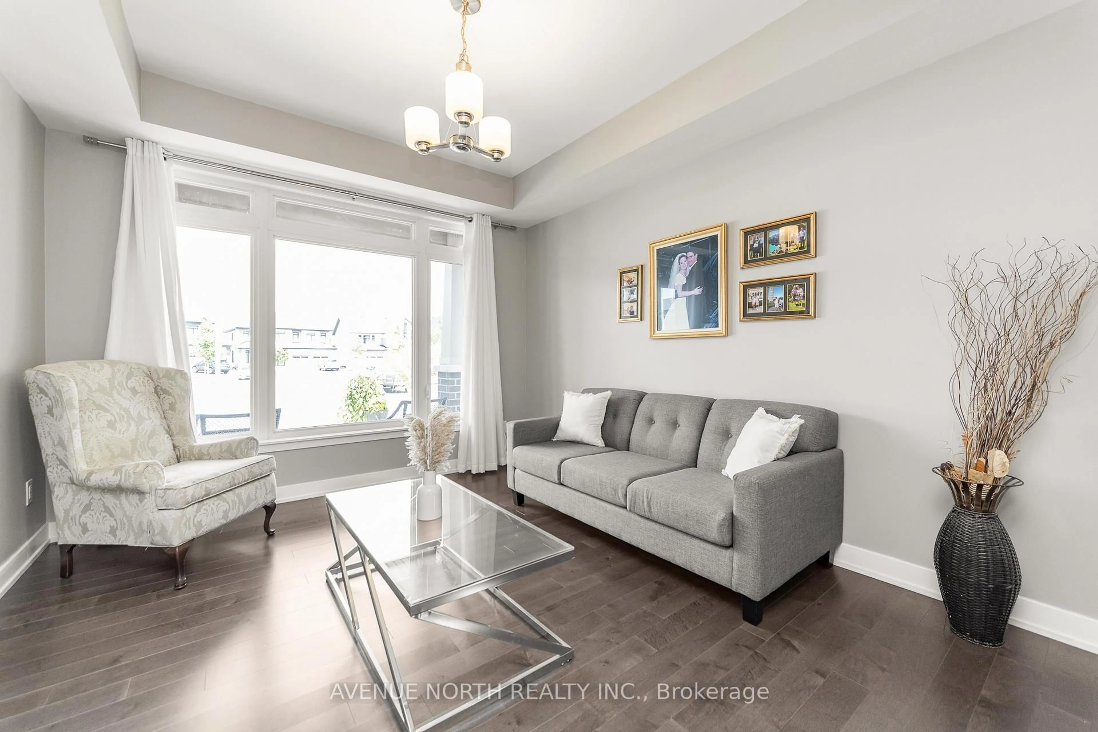 Living room with furniture, wood/laminate floor for 206 Reisling Way, Ottawa Ontario K1T 0X1