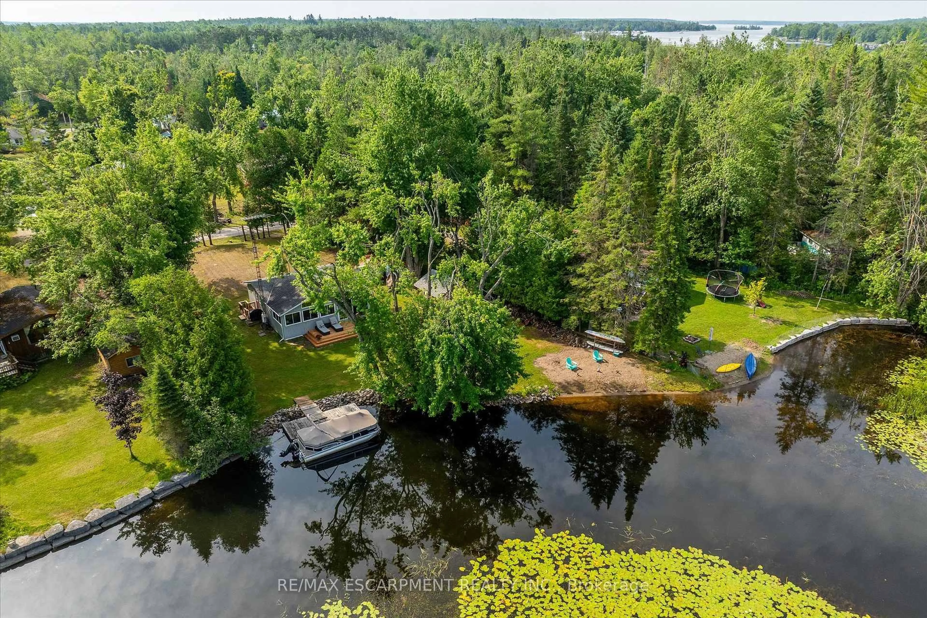 A pic from outside/outdoor area/front of a property/back of a property/a pic from drone, water/lake/river/ocean view for 38 FIRE ROUTE 104A, Trent Lakes Ontario K0M 1A0