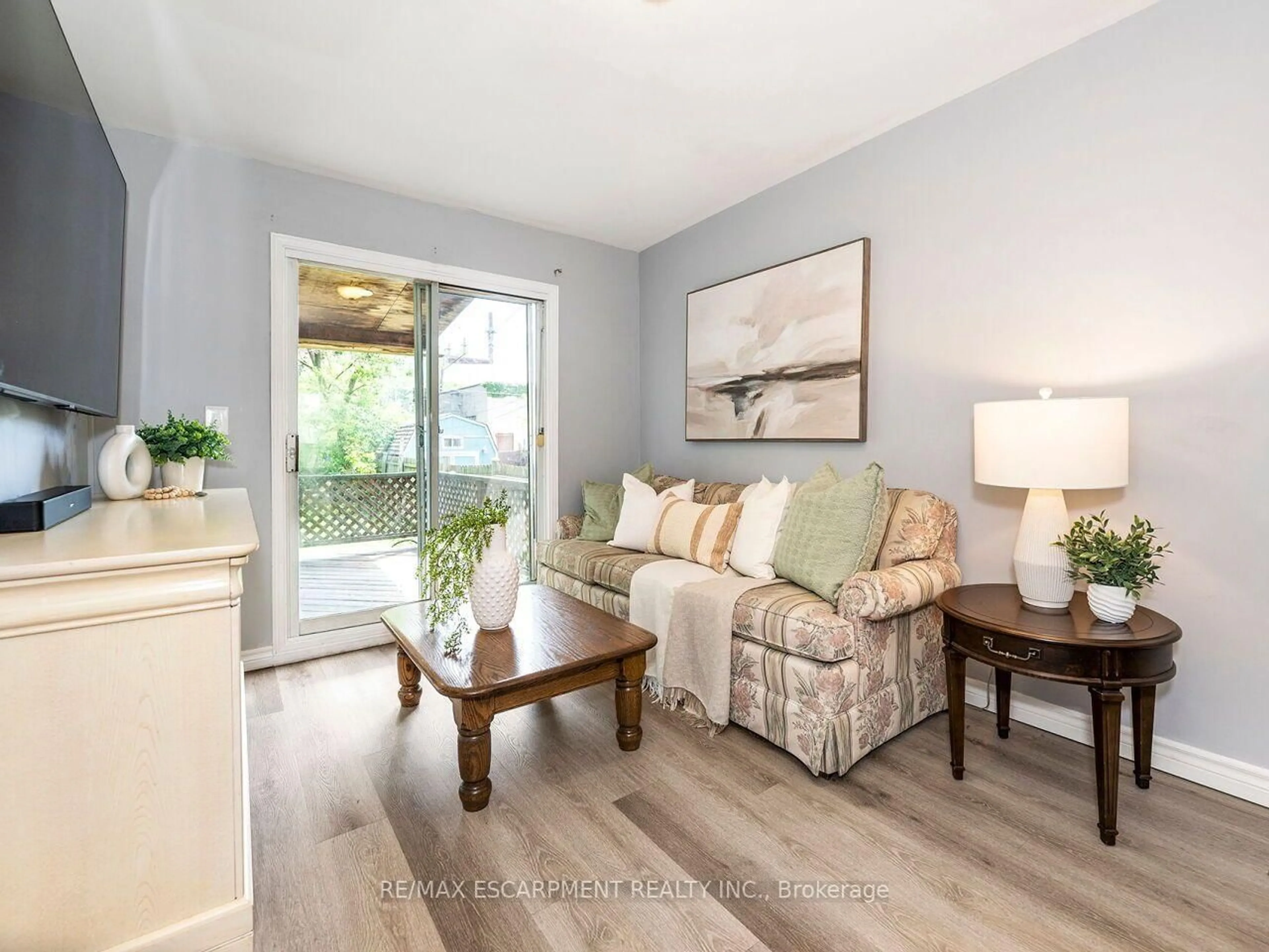 Living room with furniture, wood/laminate floor for 52 Stapleton Ave, Hamilton Ontario L8H 3N5
