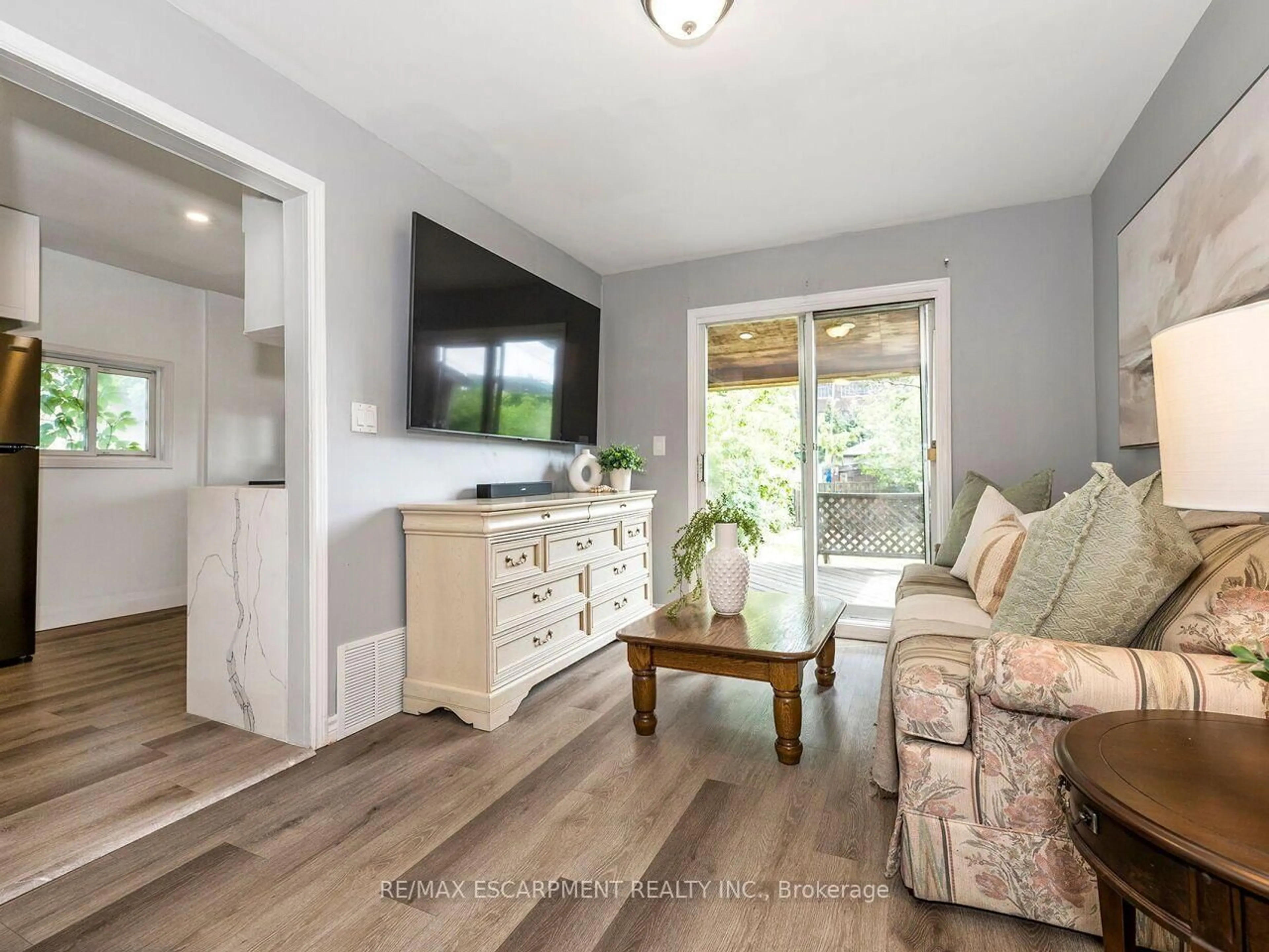 Living room with furniture, wood/laminate floor for 52 Stapleton Ave, Hamilton Ontario L8H 3N5