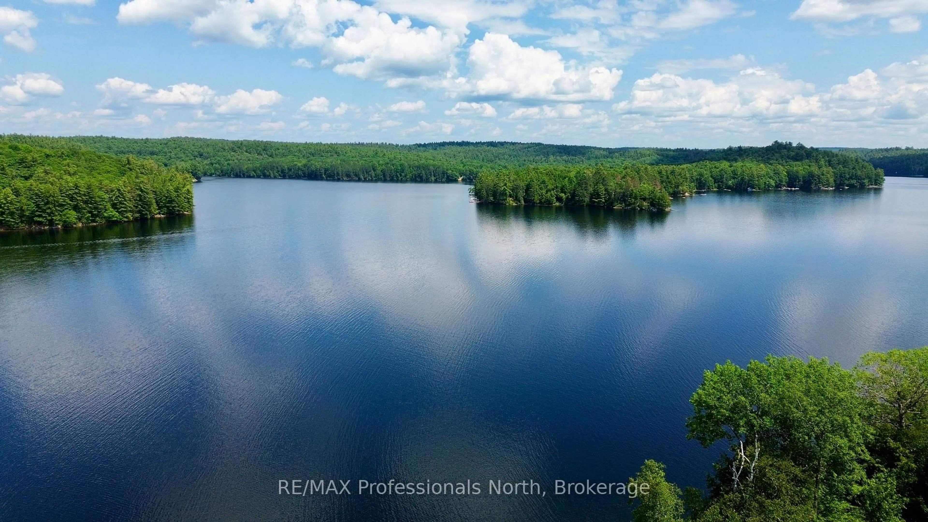 A pic from outside/outdoor area/front of a property/back of a property/a pic from drone, water/lake/river/ocean view for 1129 Comak Cres, Algonquin Highlands Ontario K0M 1J2