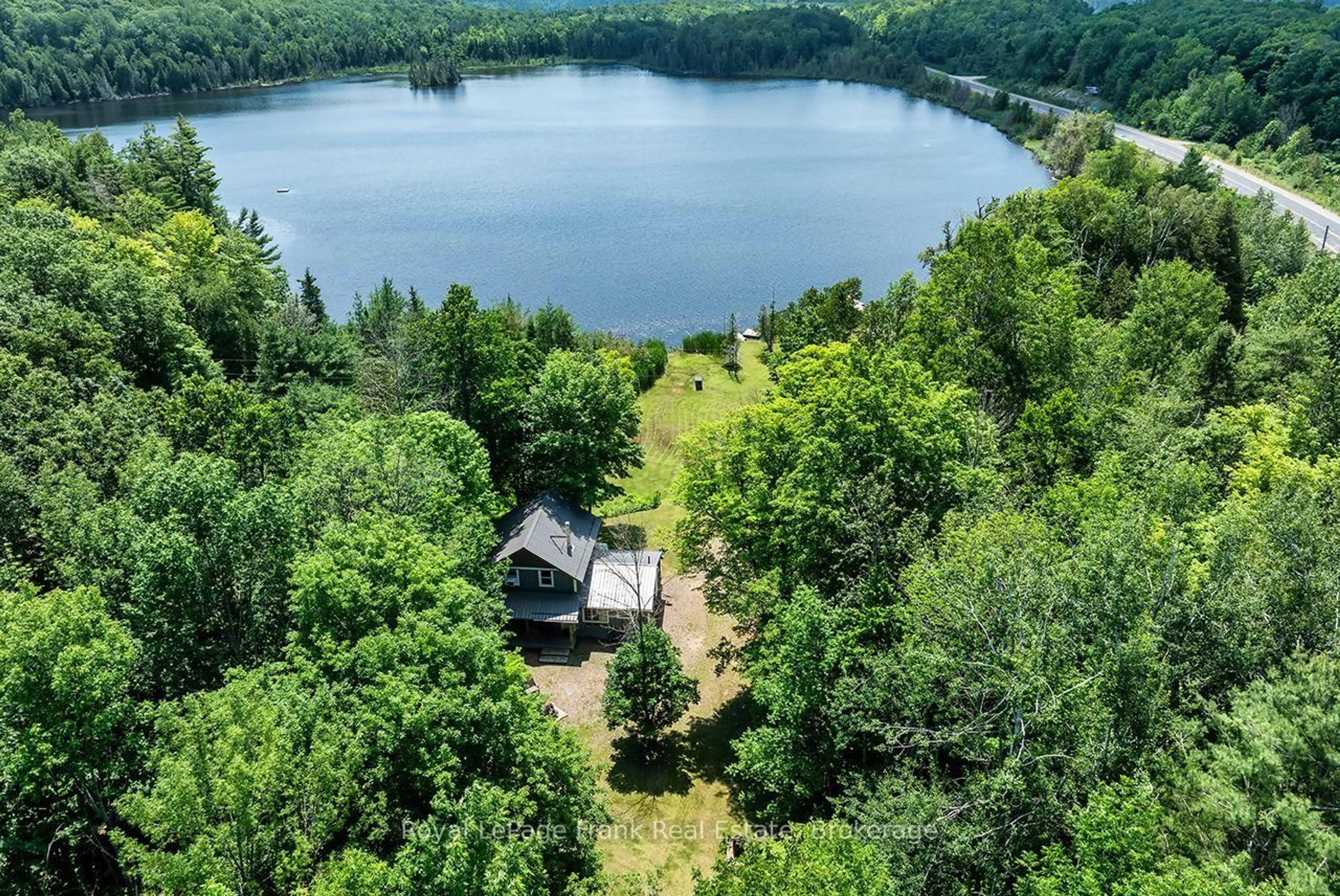 A pic from outside/outdoor area/front of a property/back of a property/a pic from drone, water/lake/river/ocean view for 1014 Riding Tr, Minden Hills Ontario K0M 2L1