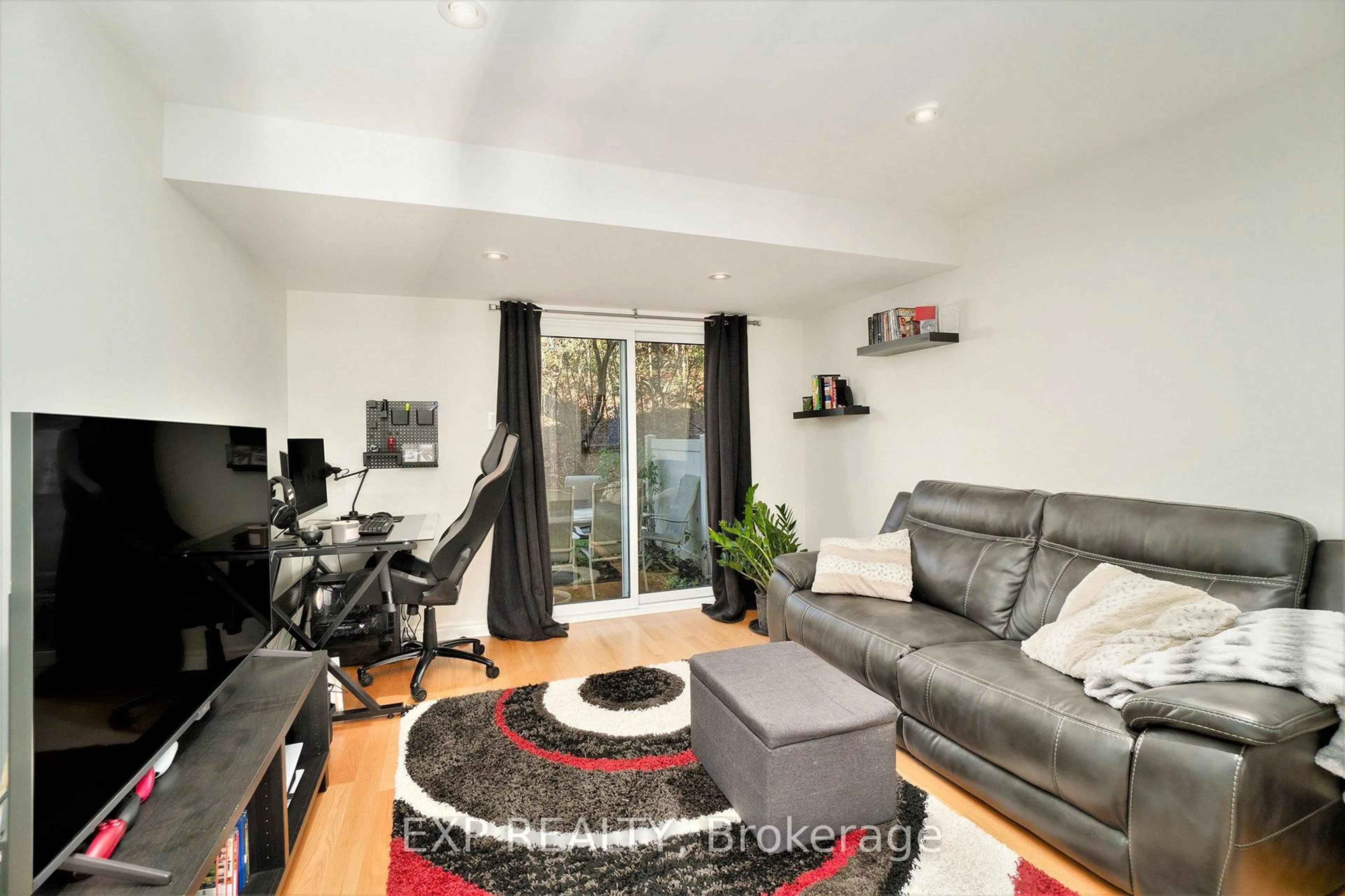 Living room with furniture, wood/laminate floor for 6667 Bilberry Dr, Ottawa Ontario K1C 4N5