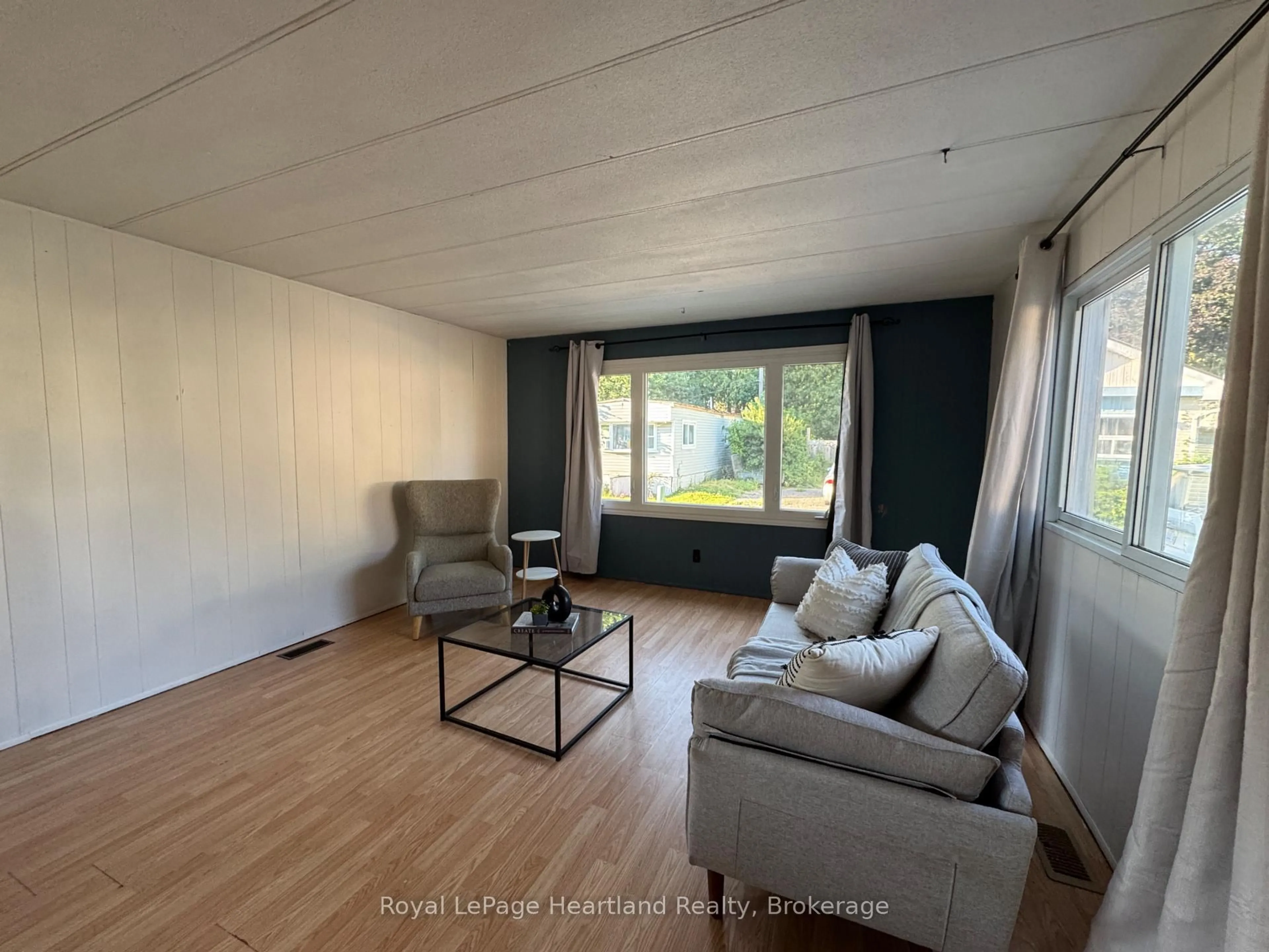 Living room with furniture, wood/laminate floor for 4 Trailer Park Rd, Minto Ontario N0G 2P0