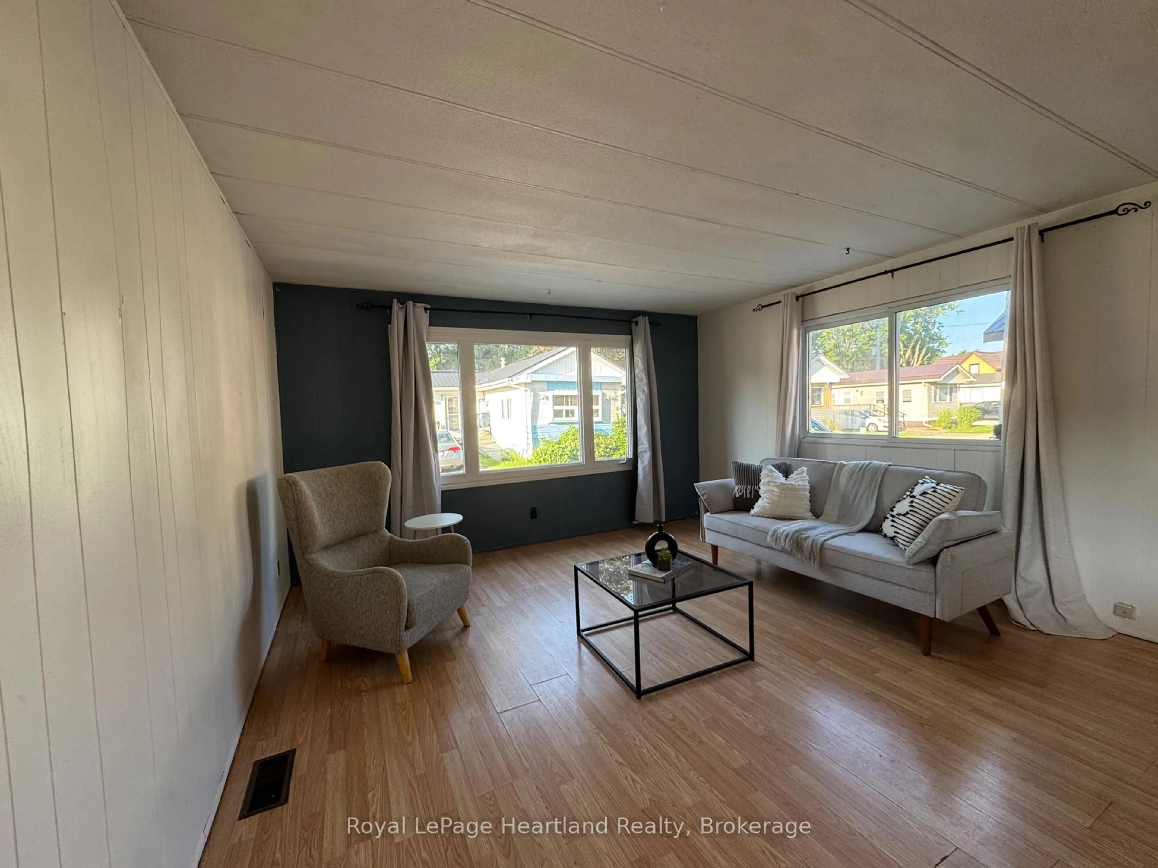 Living room with furniture, wood/laminate floor for 4 Trailer Park Rd, Minto Ontario N0G 2P0
