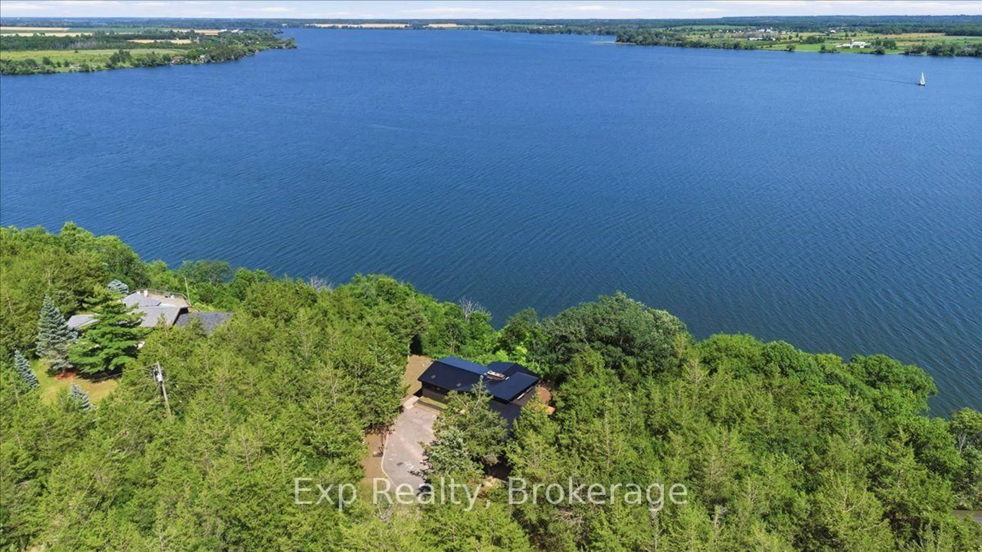 A pic from outside/outdoor area/front of a property/back of a property/a pic from drone, water/lake/river/ocean view for 23 Sidney Shore Lane, Prince Edward County Ontario K0K 2T0