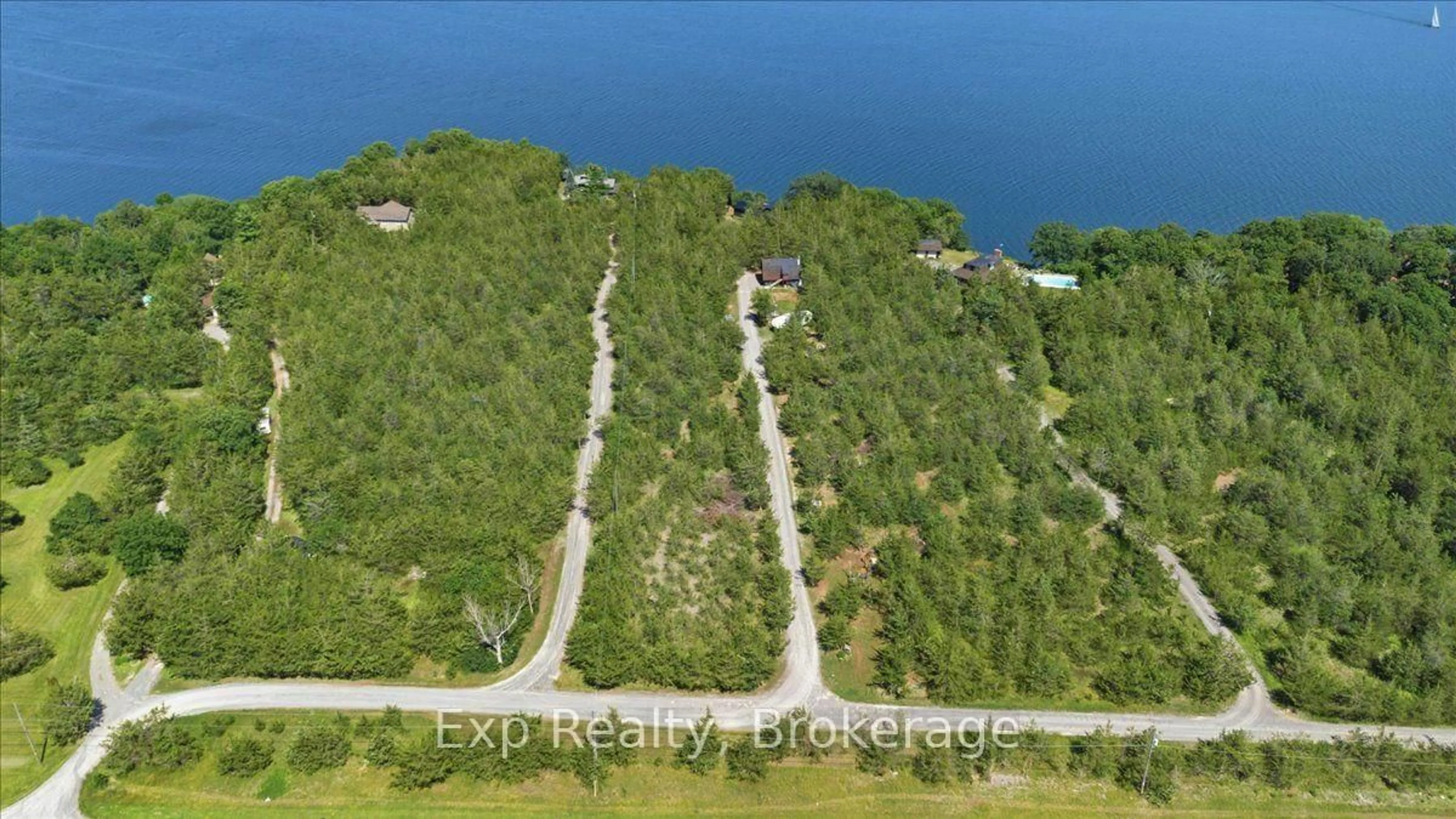 A pic from outside/outdoor area/front of a property/back of a property/a pic from drone, water/lake/river/ocean view for 23 Sidney Shore Lane, Prince Edward County Ontario K0K 2T0