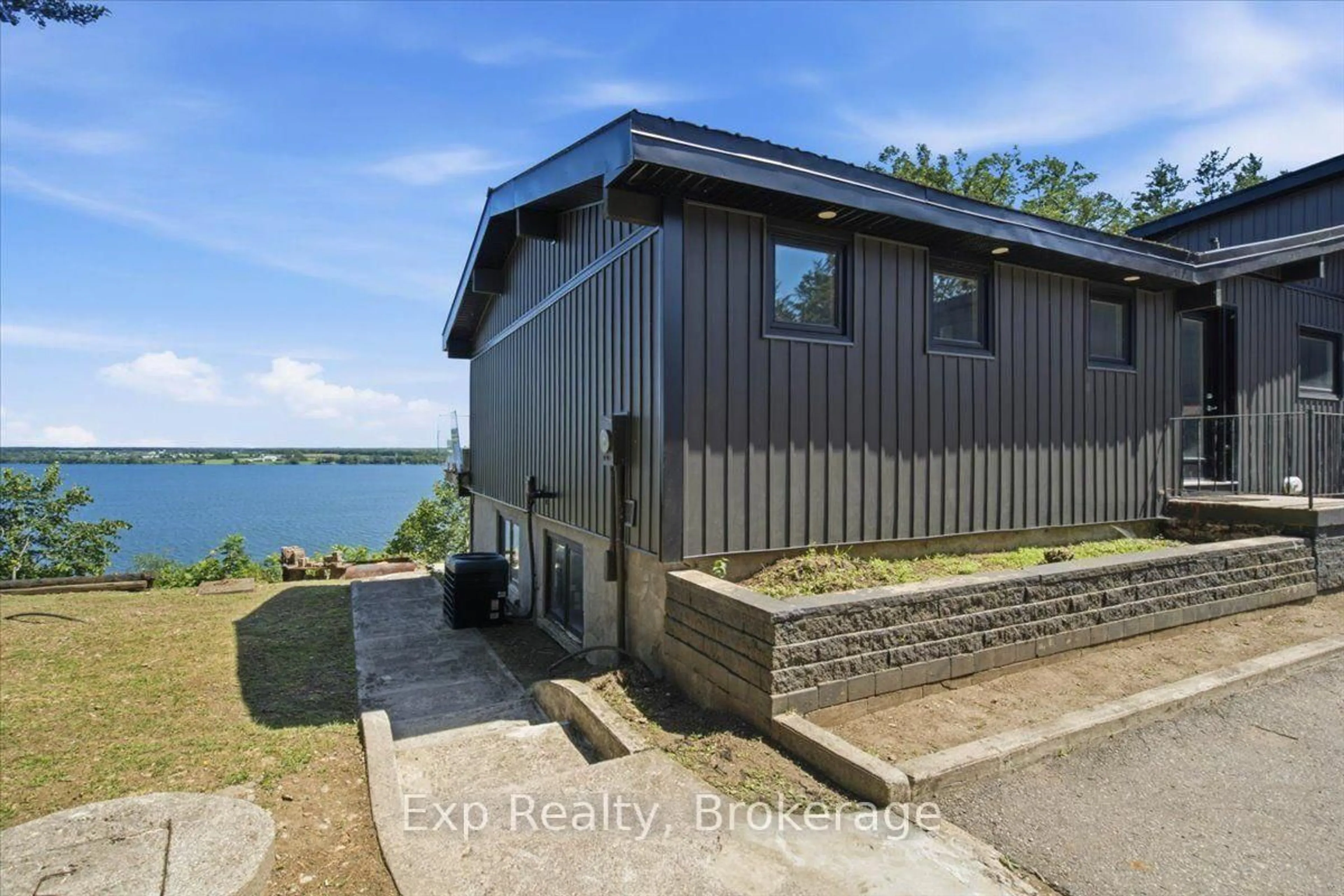 A pic from outside/outdoor area/front of a property/back of a property/a pic from drone, water/lake/river/ocean view for 23 Sidney Shore Lane, Prince Edward County Ontario K0K 2T0