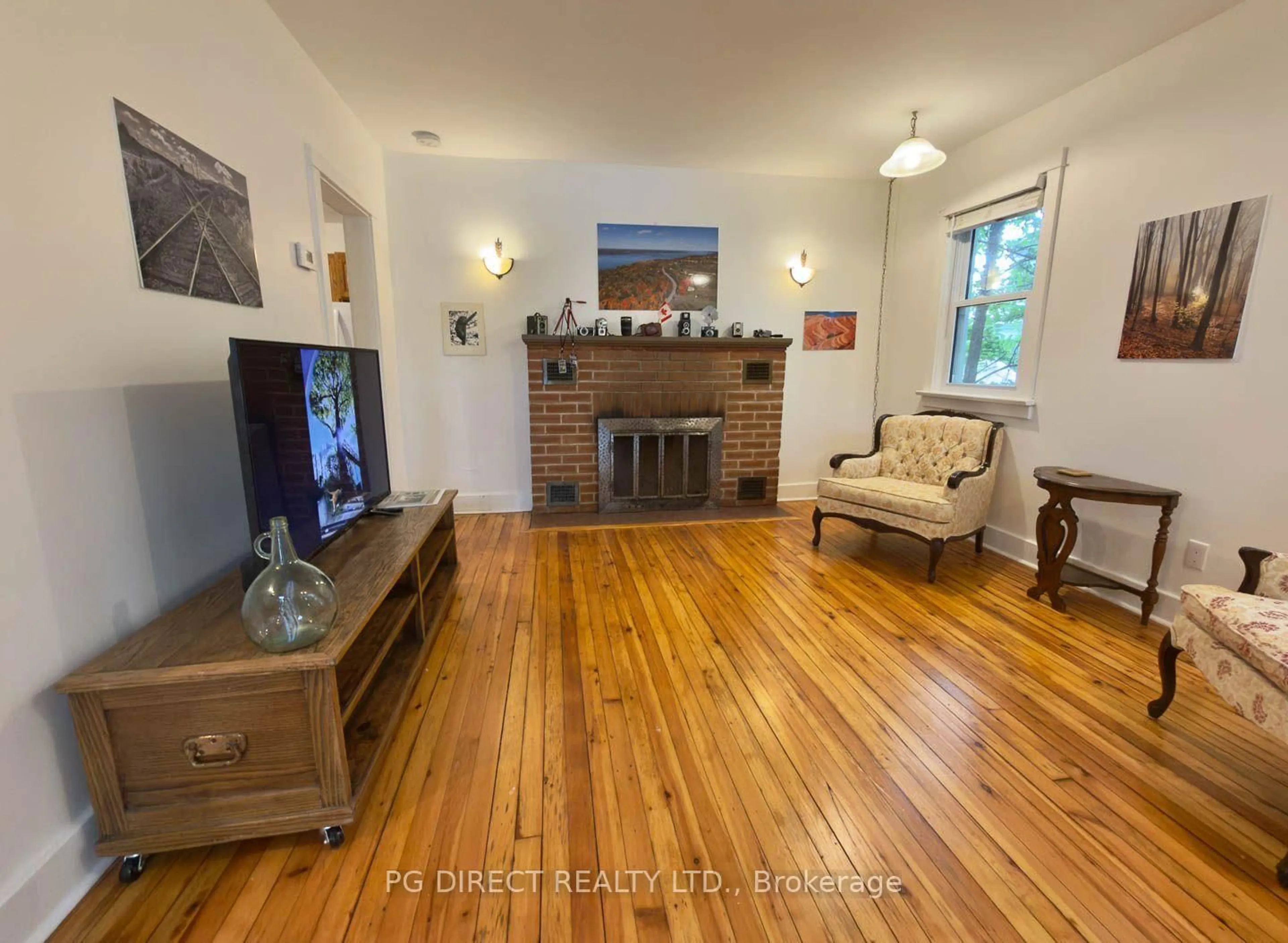 Living room with furniture, wood/laminate floor for 4 Chapel St, Prince Edward County Ontario K0K 2T0