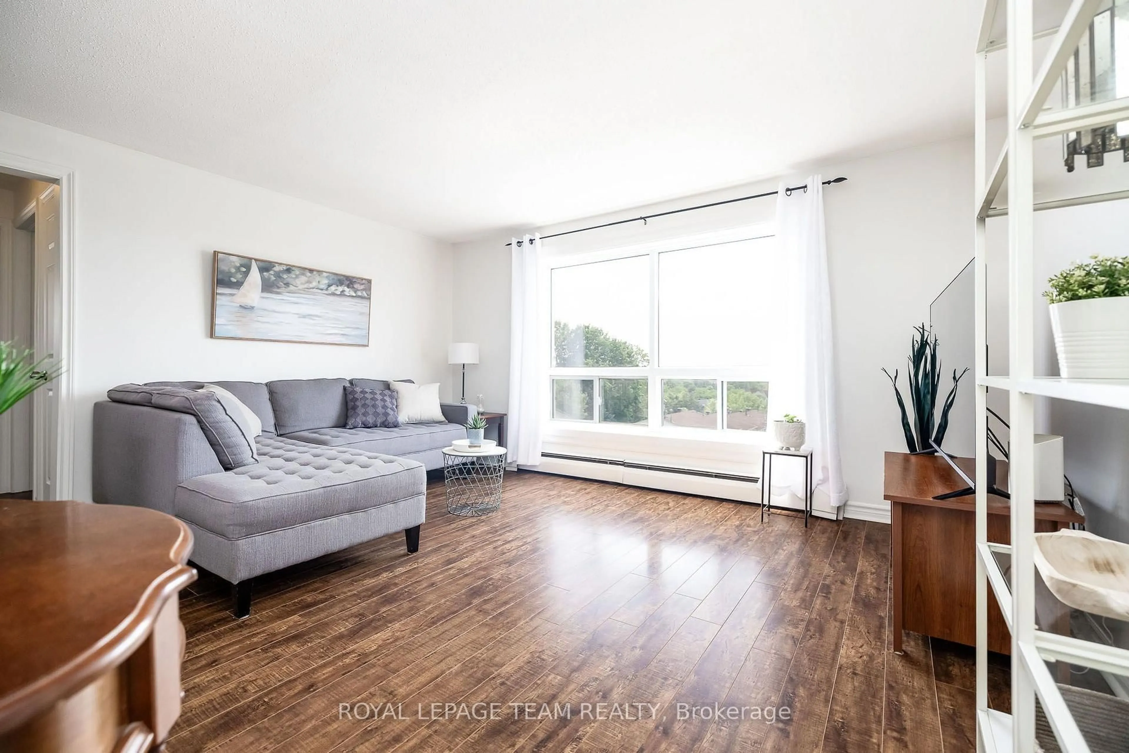 Living room with furniture, wood/laminate floor for 47 Sumac St #12, Ottawa Ontario K1J 7T7