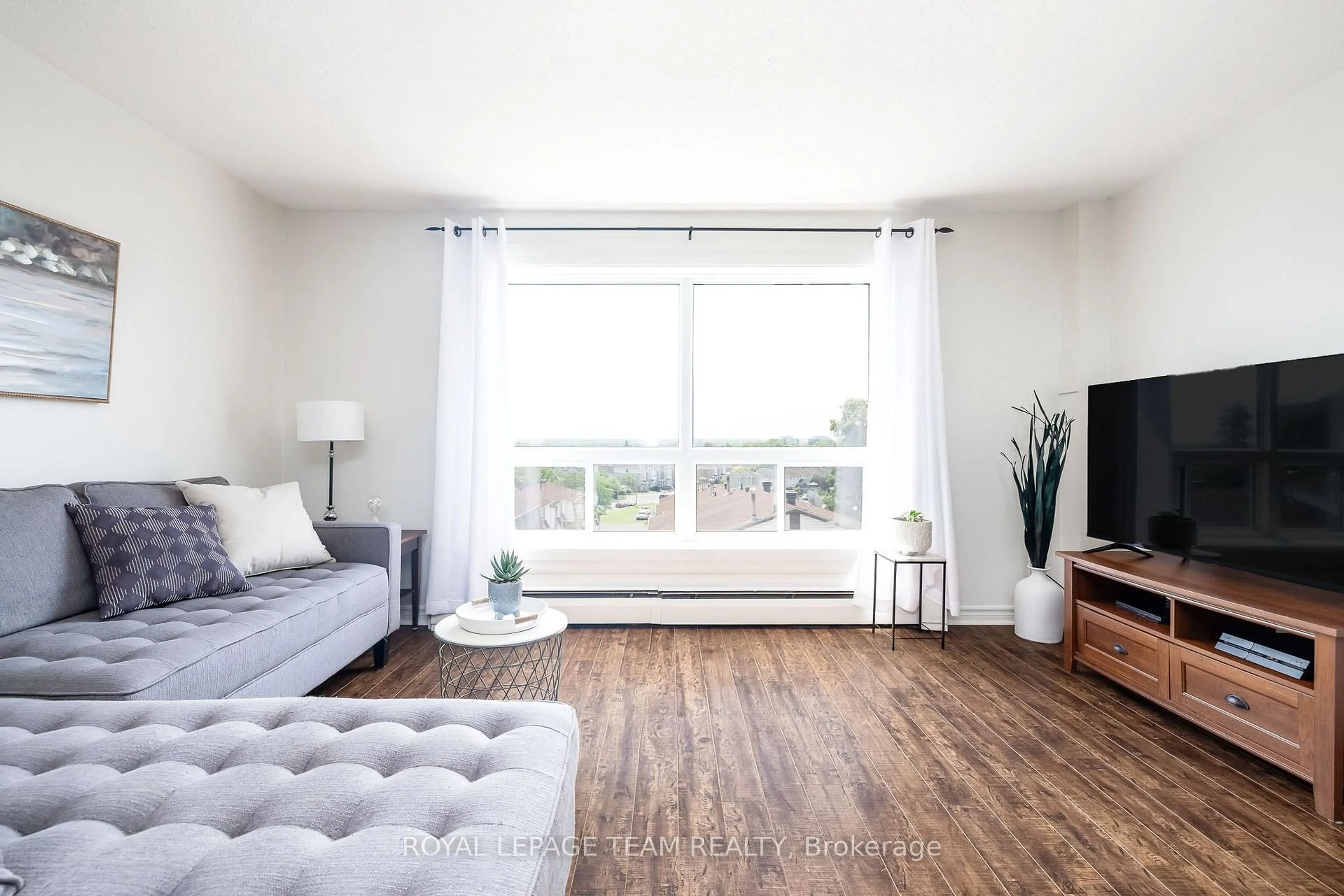 Living room with furniture, wood/laminate floor for 47 Sumac St #12, Ottawa Ontario K1J 7T7