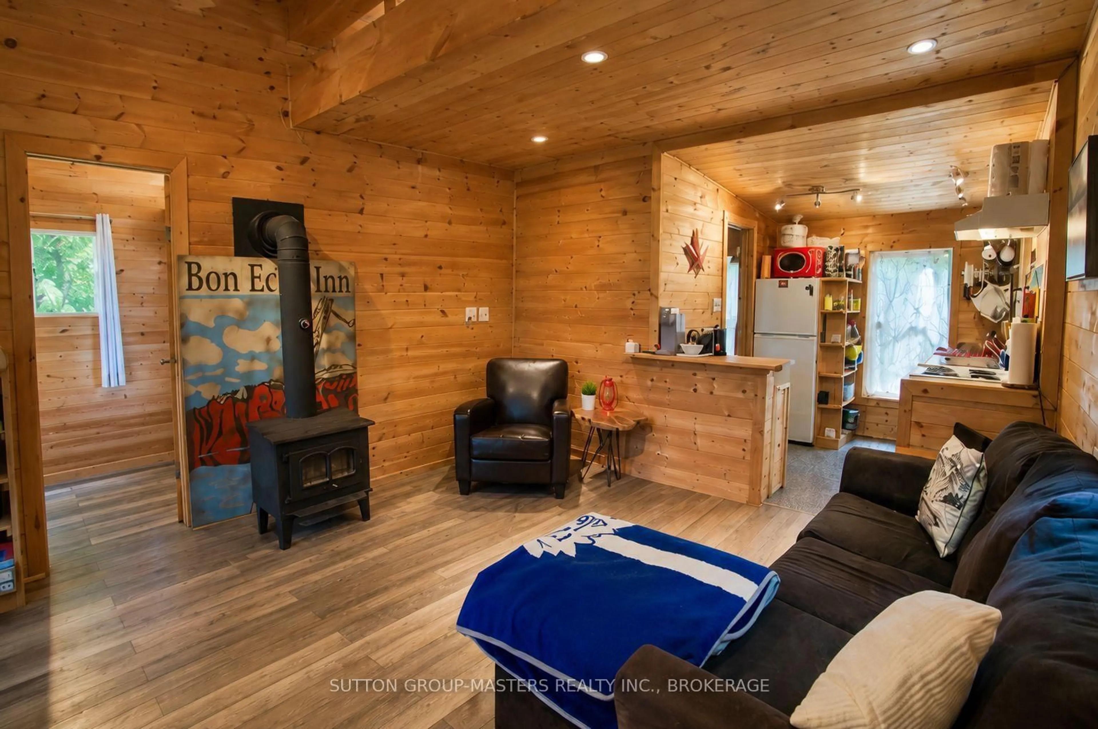 Living room with furniture, wood/laminate floor for 2282 Myers Cave Rd, Cloyne Ontario K0H 1K0