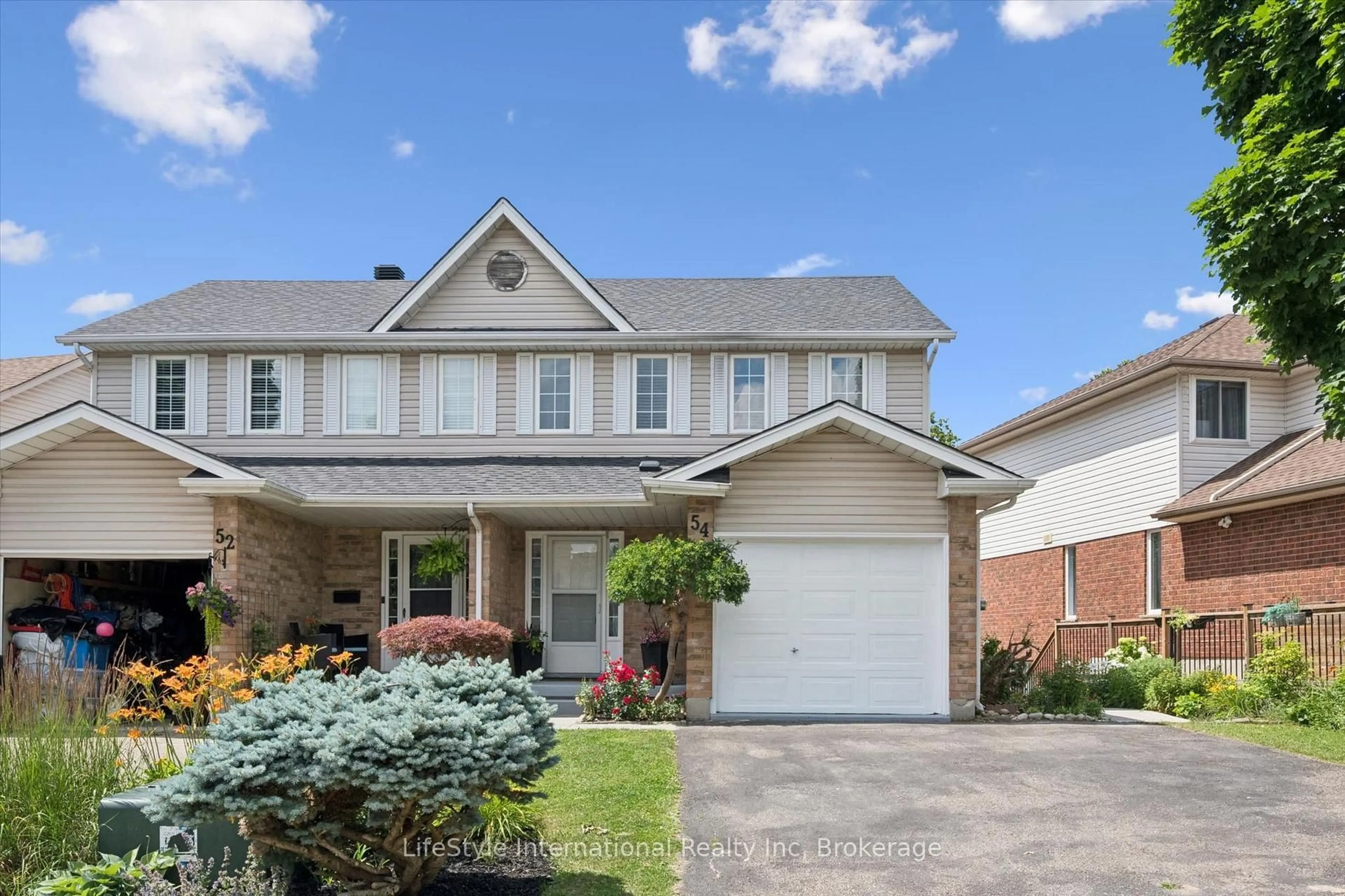 Home with brick exterior material, street for 54 Chesterton Lane, Guelph Ontario N1E 6S8