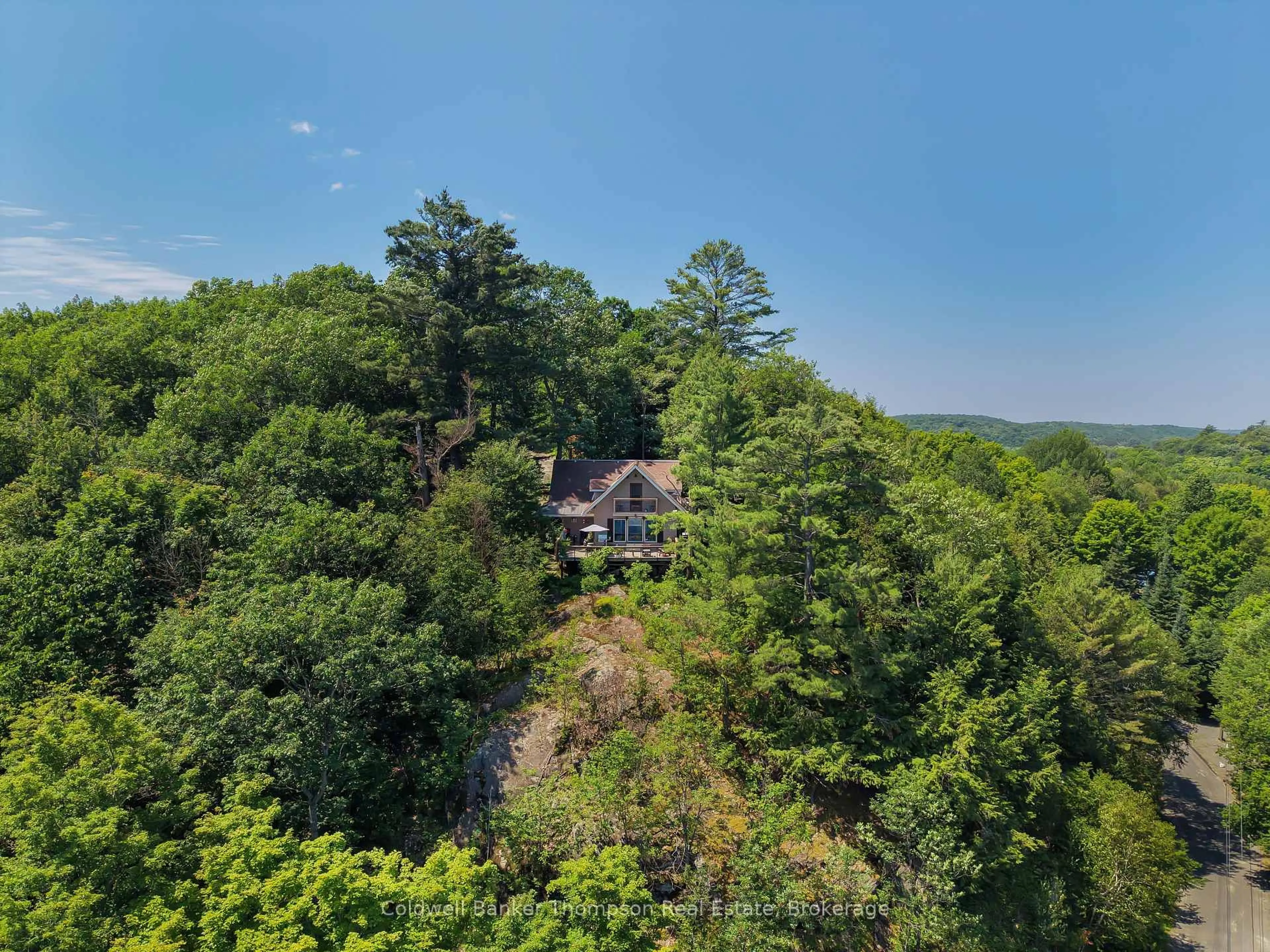 A pic from outside/outdoor area/front of a property/back of a property/a pic from drone, forest/trees view for 300 South Dr, Huntsville Ontario P1H 2J2