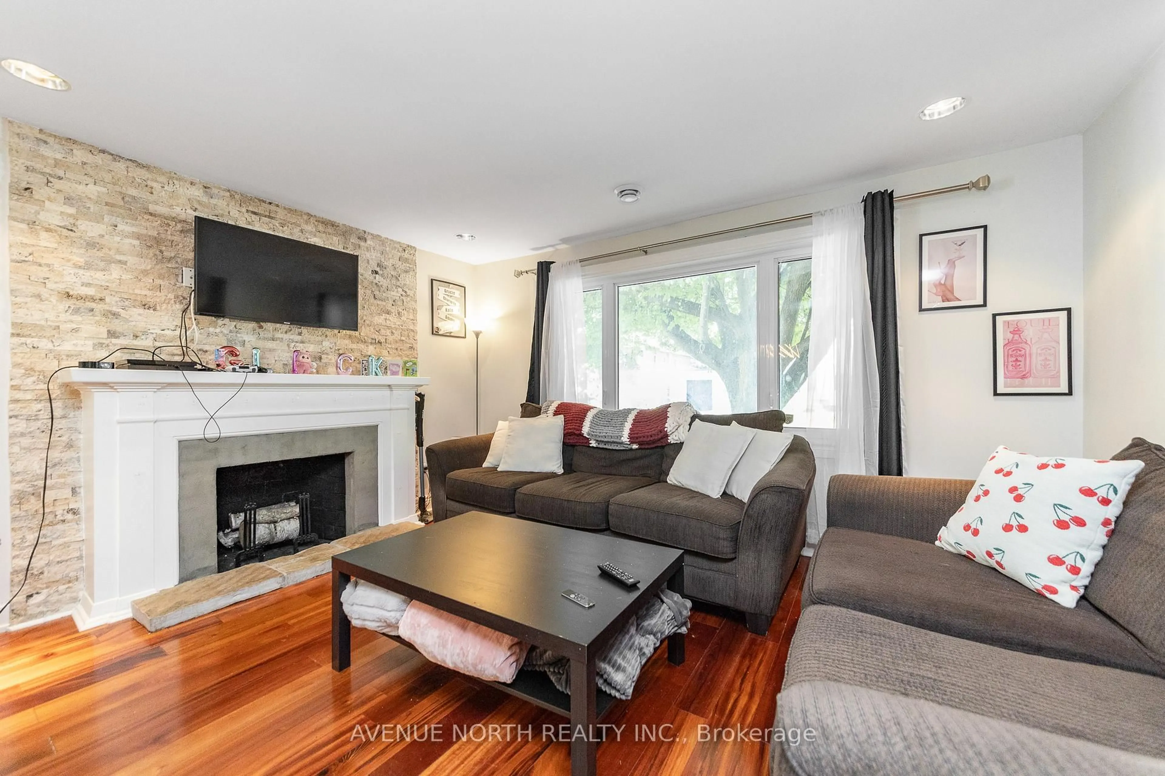 Living room with furniture, wood/laminate floor for 206 Blackburn Ave, Ottawa Ontario K1N 8A8