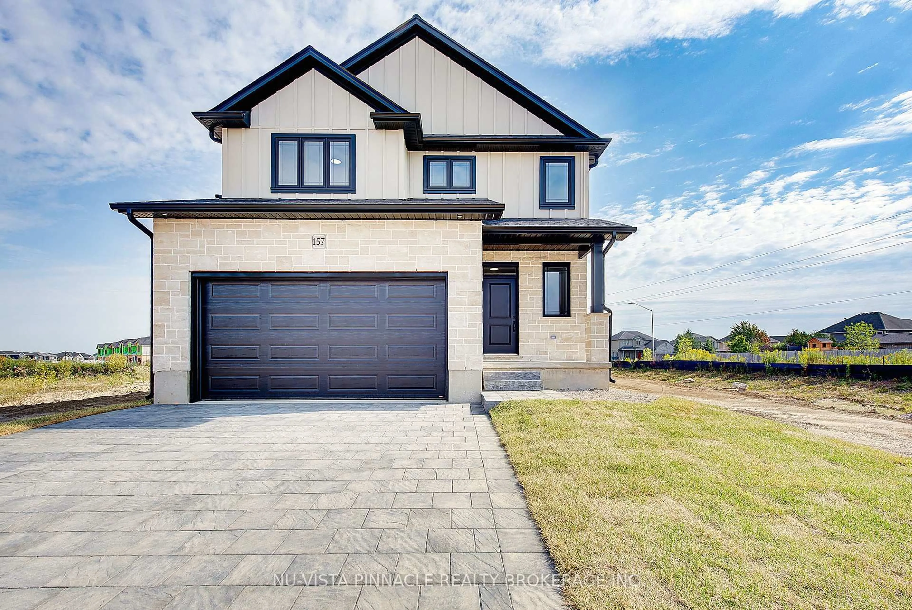 Home with brick exterior material, street for 10 Woodmere Path, Middlesex Centre Ontario N0M 2A0