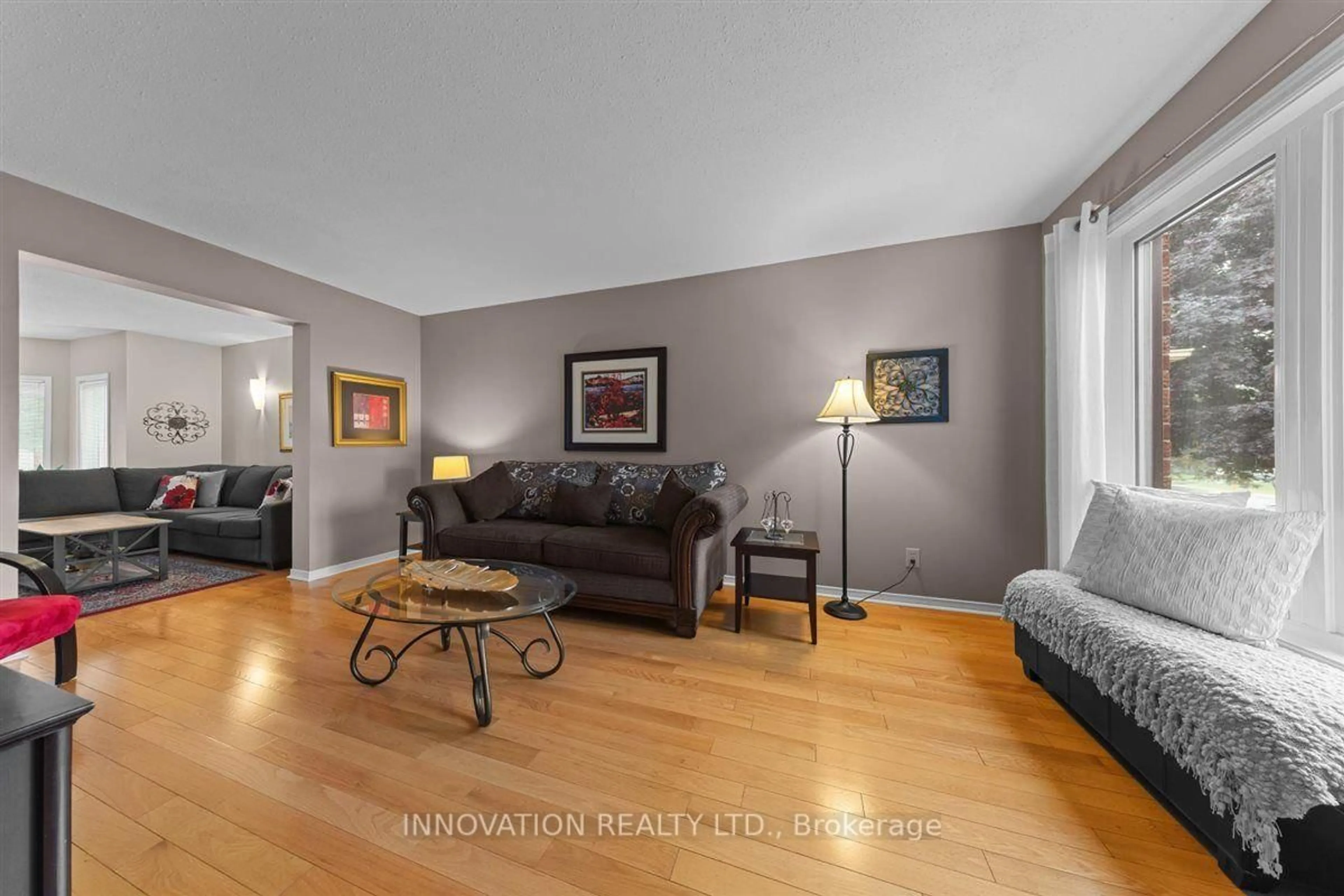 Living room with furniture, wood/laminate floor for 183 Equestrian Dr, Kanata Ontario K2M 1K6