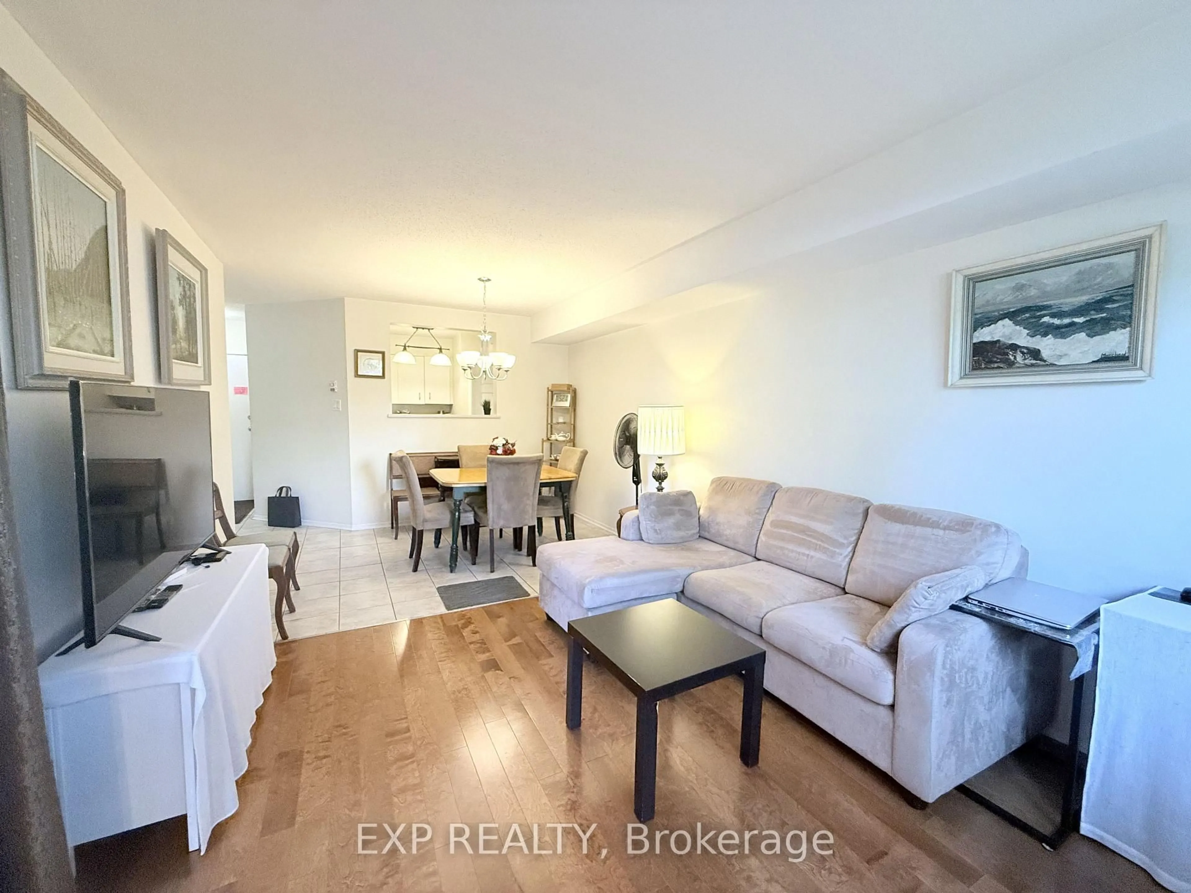 Living room with furniture, wood/laminate floor for 316 Lorry Greenberg Dr #122, Ottawa Ontario K1T 2P4