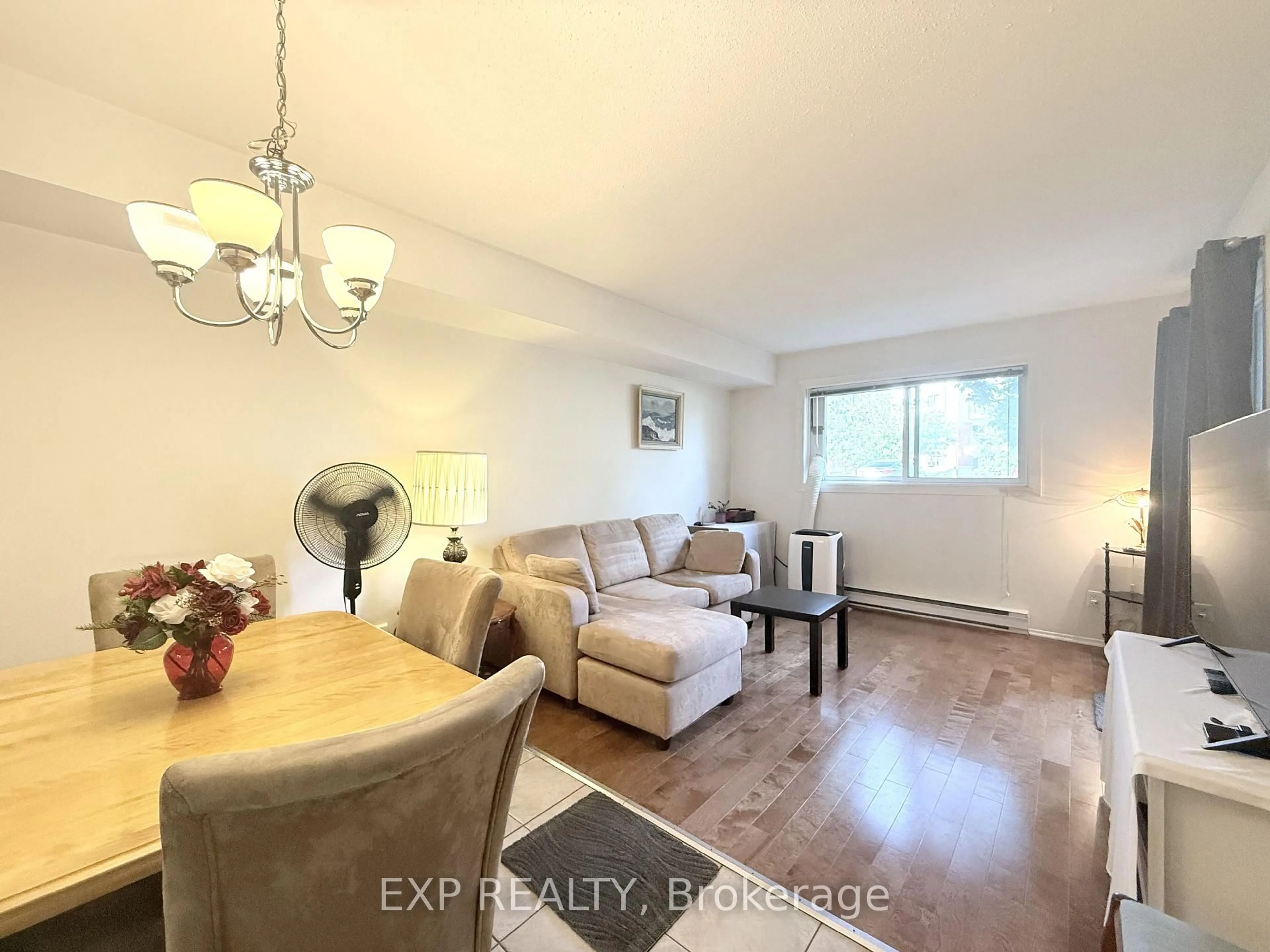 Living room with furniture, wood/laminate floor for 316 Lorry Greenberg Dr #122, Ottawa Ontario K1T 2P4