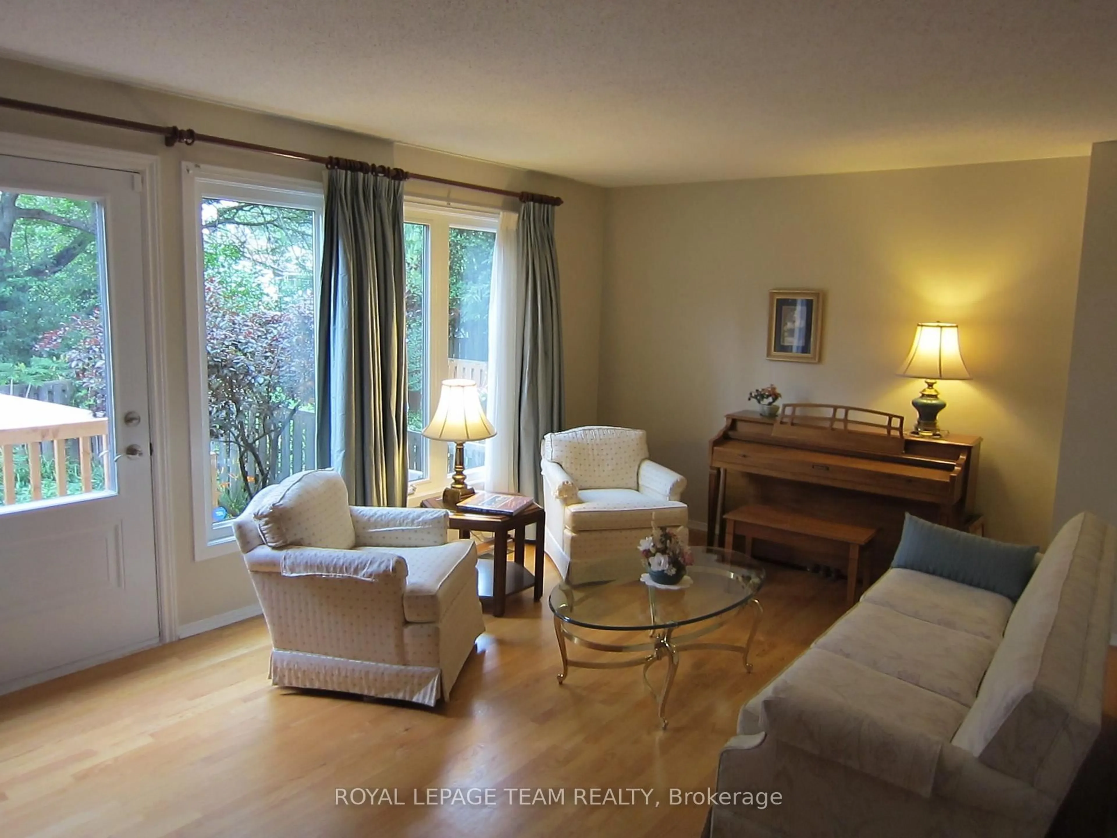Living room with furniture, wood/laminate floor for 200 Owl Dr #67, Ottawa Ontario K1V 9P7