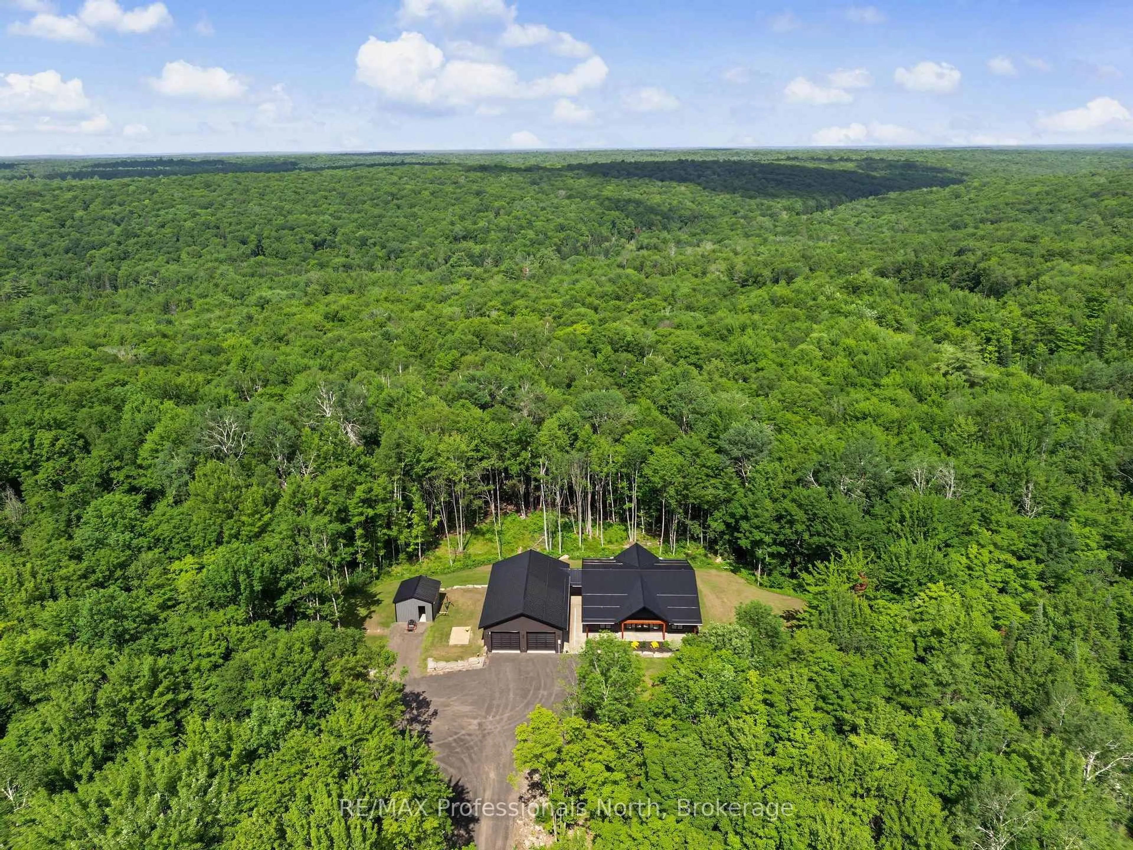 A pic from outside/outdoor area/front of a property/back of a property/a pic from drone, forest/trees view for 1541 Bobcaygeon Rd, Minden Hills Ontario K0M 2K0