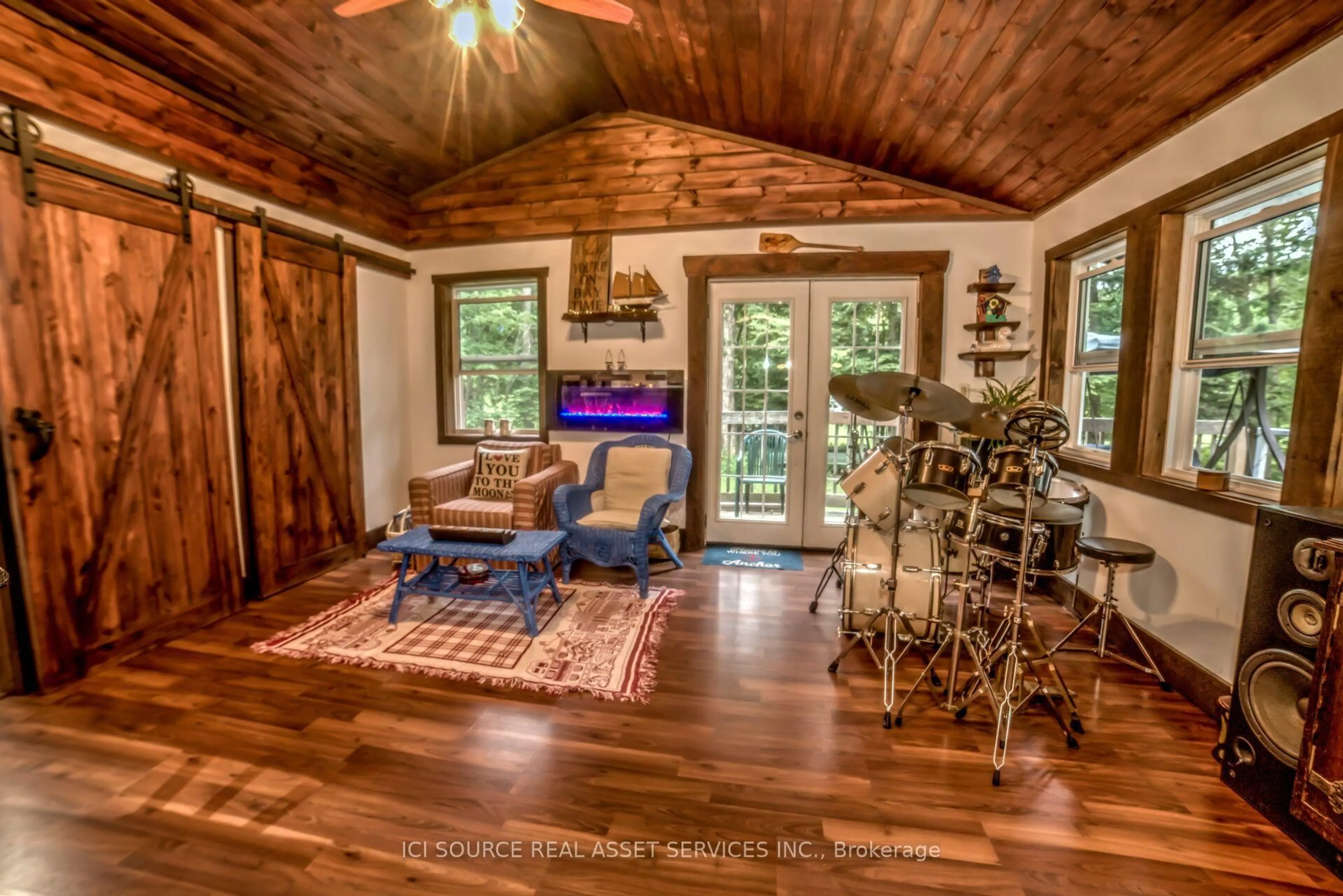 Living room with furniture, wood/laminate floor for 1218 Milford Bay Rd #Unit 5, Muskoka Lakes Ontario P0B 1E0