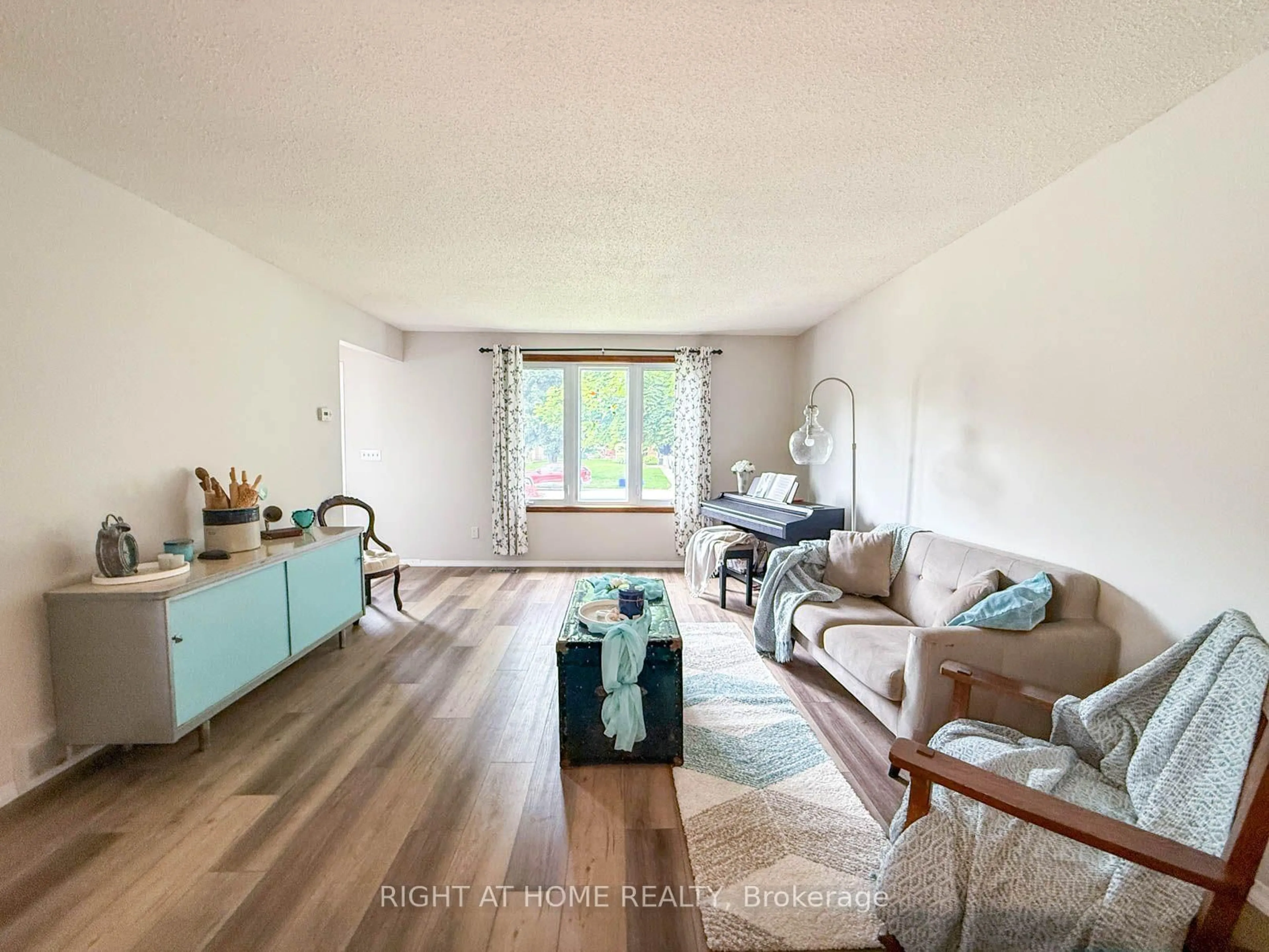 Living room with furniture, wood/laminate floor for 2623 Kaymar Cres, Sarnia Ontario N0N 1C0