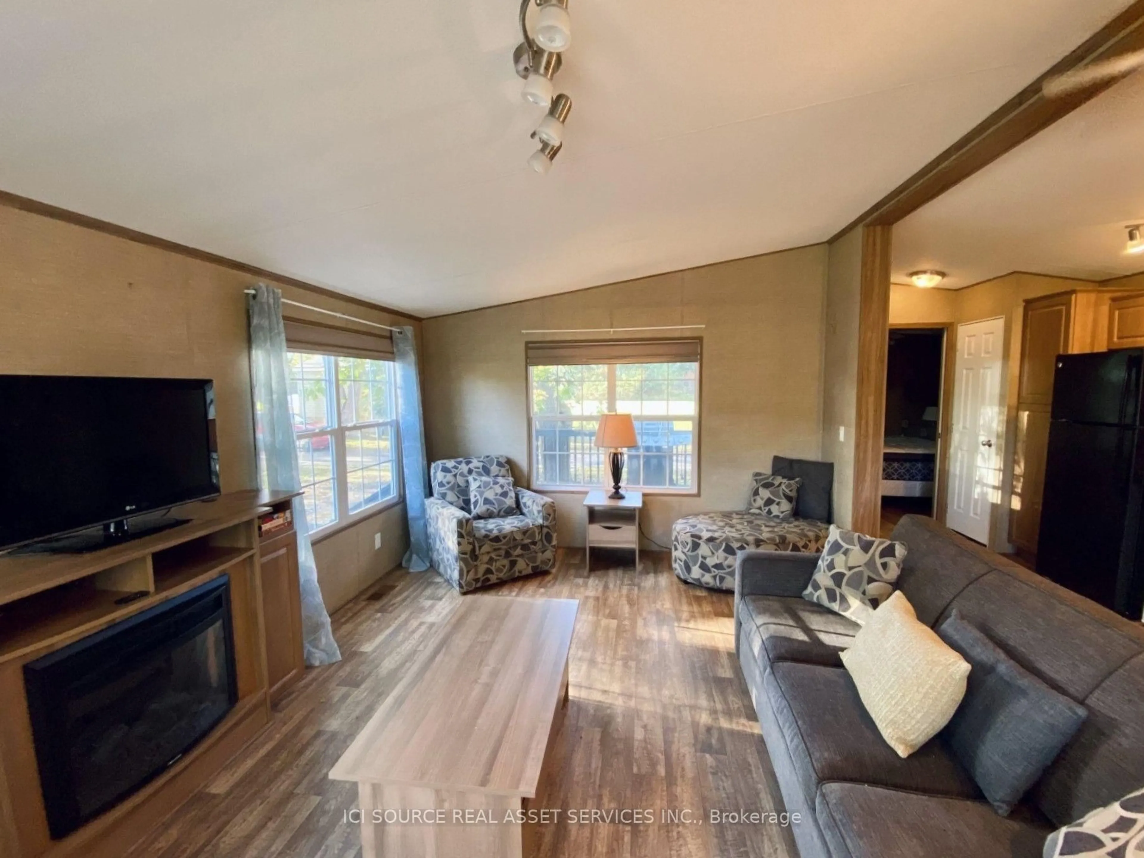 Living room with furniture, wood/laminate floor for 486 County Road 18 #DDCB18, Prince Edward County Ontario K0K 1P0