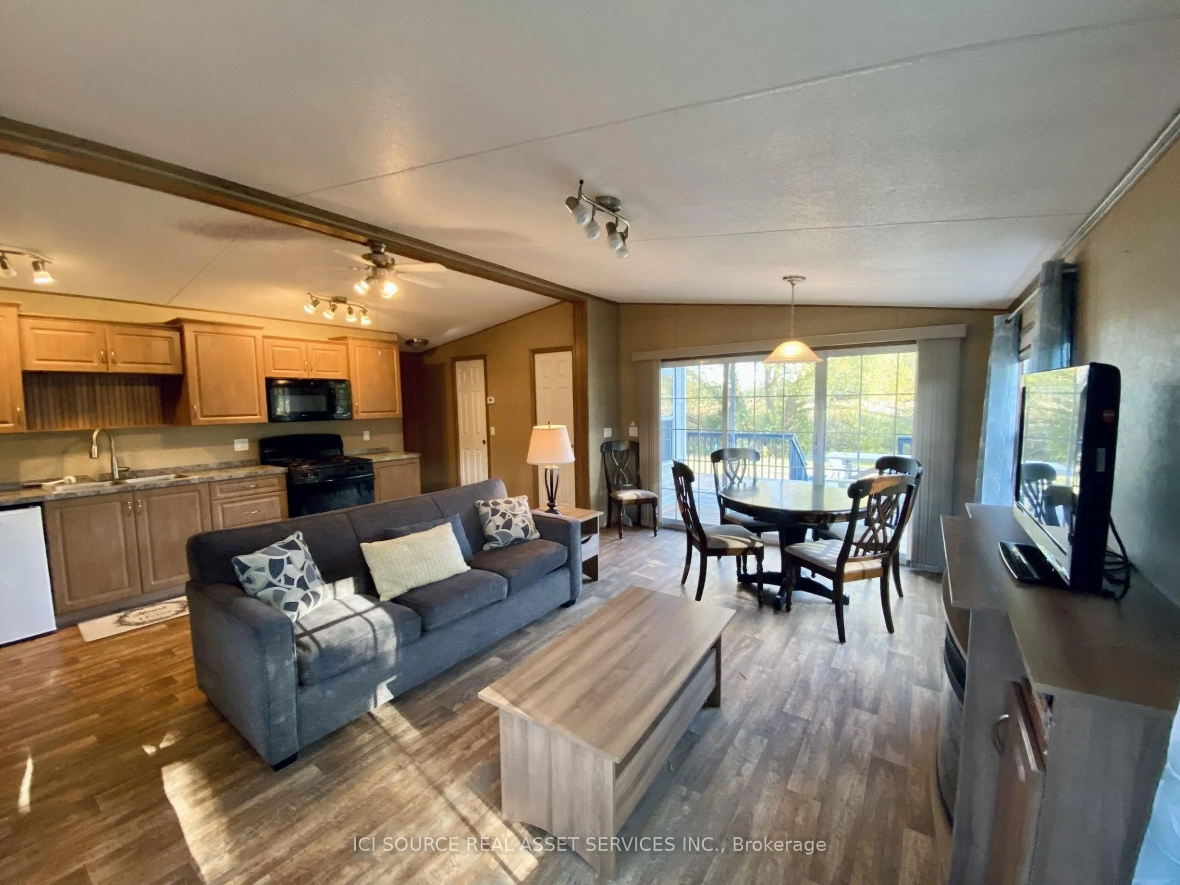 Living room with furniture, wood/laminate floor for 486 County Road 18 #DDCB18, Prince Edward County Ontario K0K 1P0
