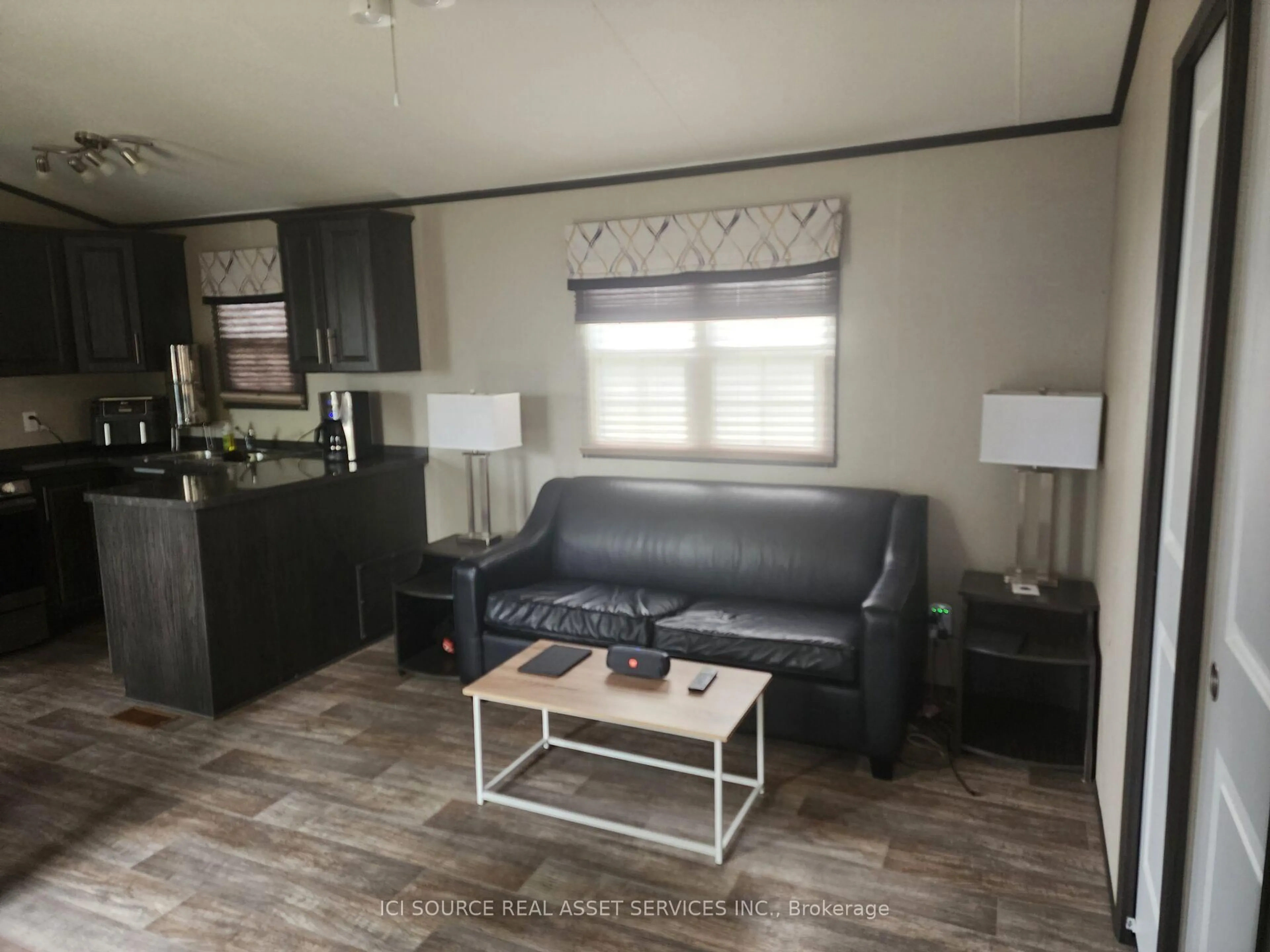 Living room with furniture, wood/laminate floor for 1235 Villiers Line #CLBW32, Otonabee-South Monaghan Ontario K0L 2G0