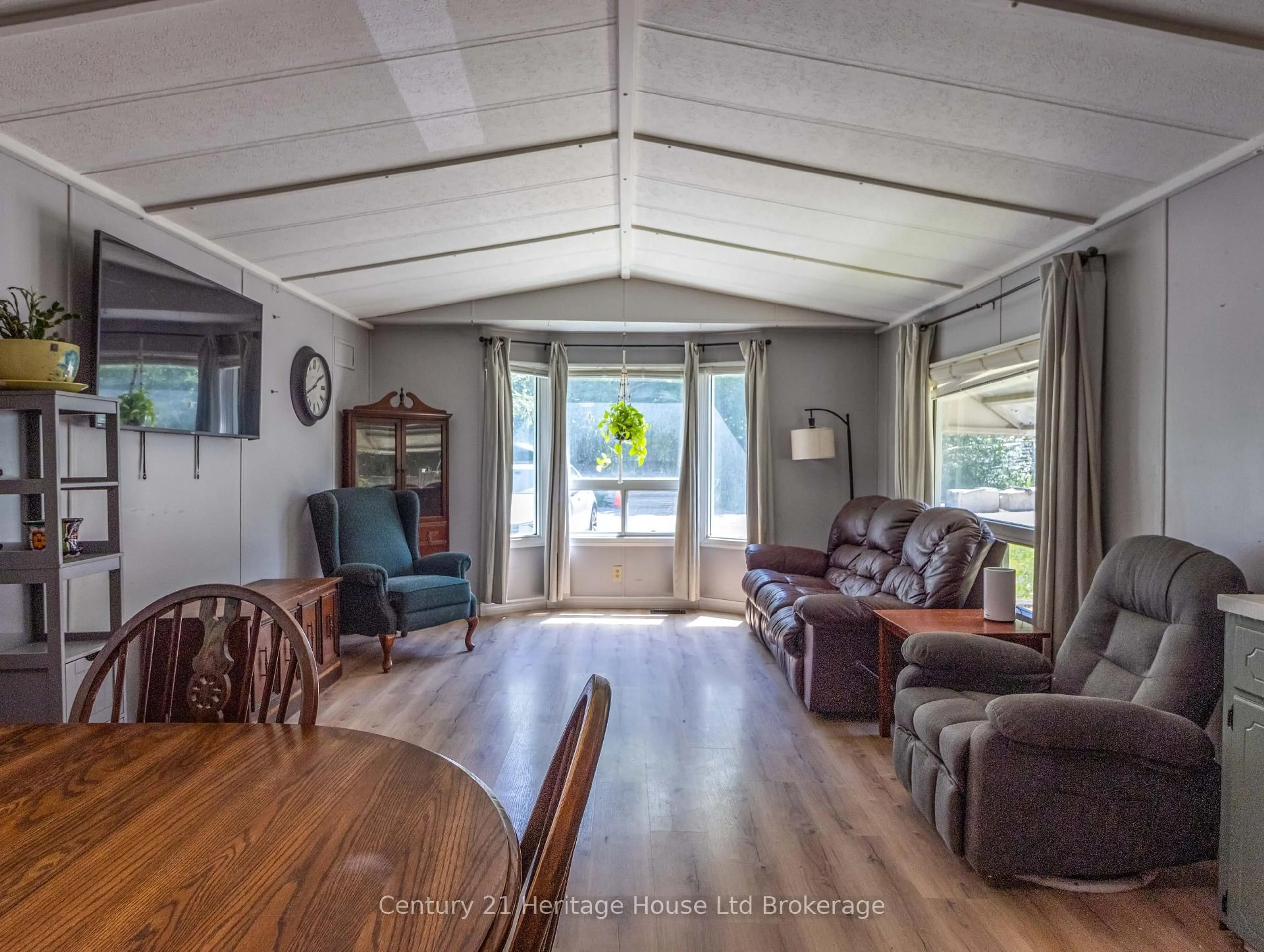 Living room with furniture, wood/laminate floor for 596101 Oxford 59 Rd #4 Centre Rd, East Zorra-Tavistock Ontario N4S 7W1