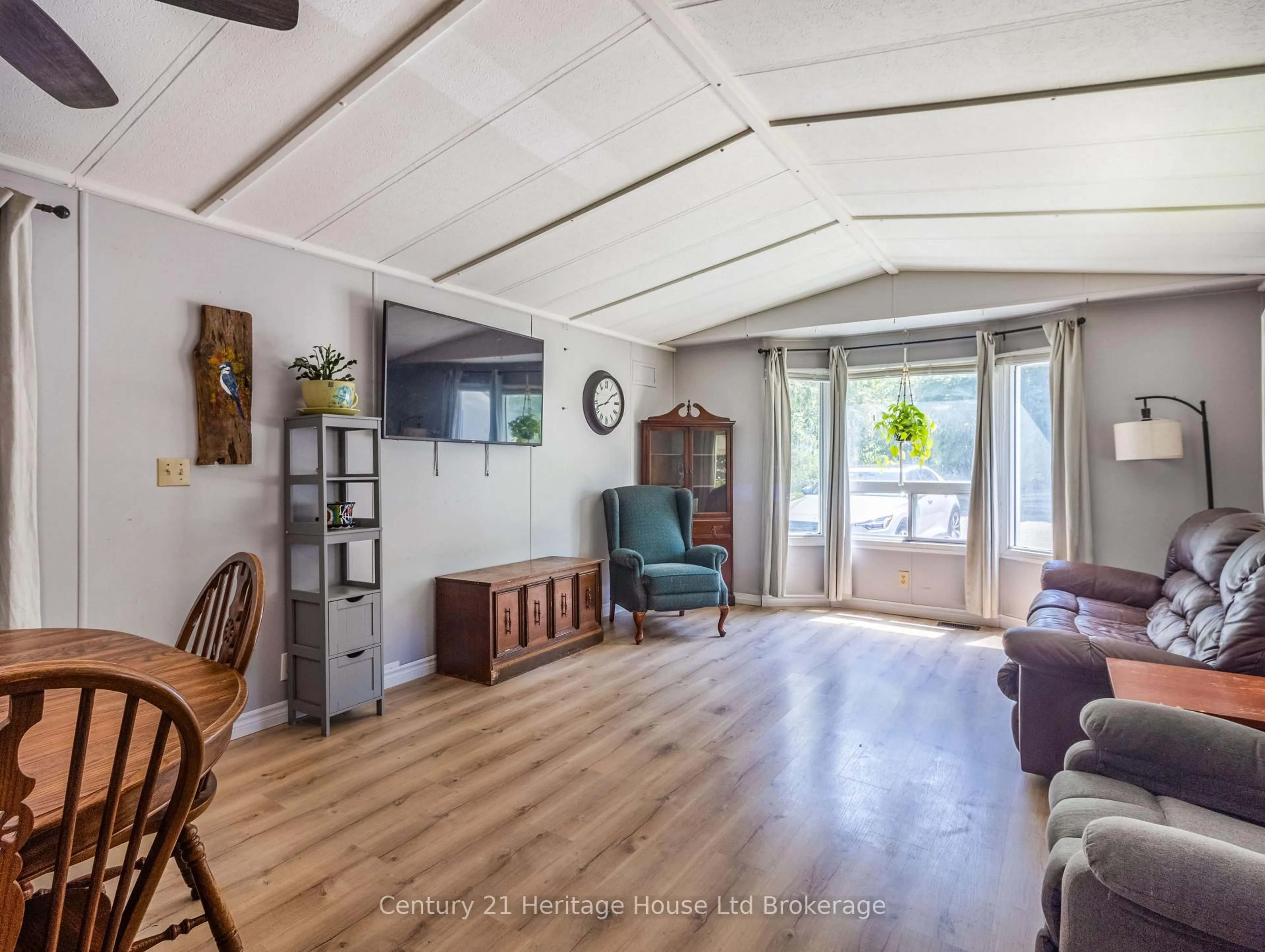 Living room with furniture, wood/laminate floor for 596101 Oxford 59 Rd #4 Centre Rd, East Zorra-Tavistock Ontario N4S 7W1