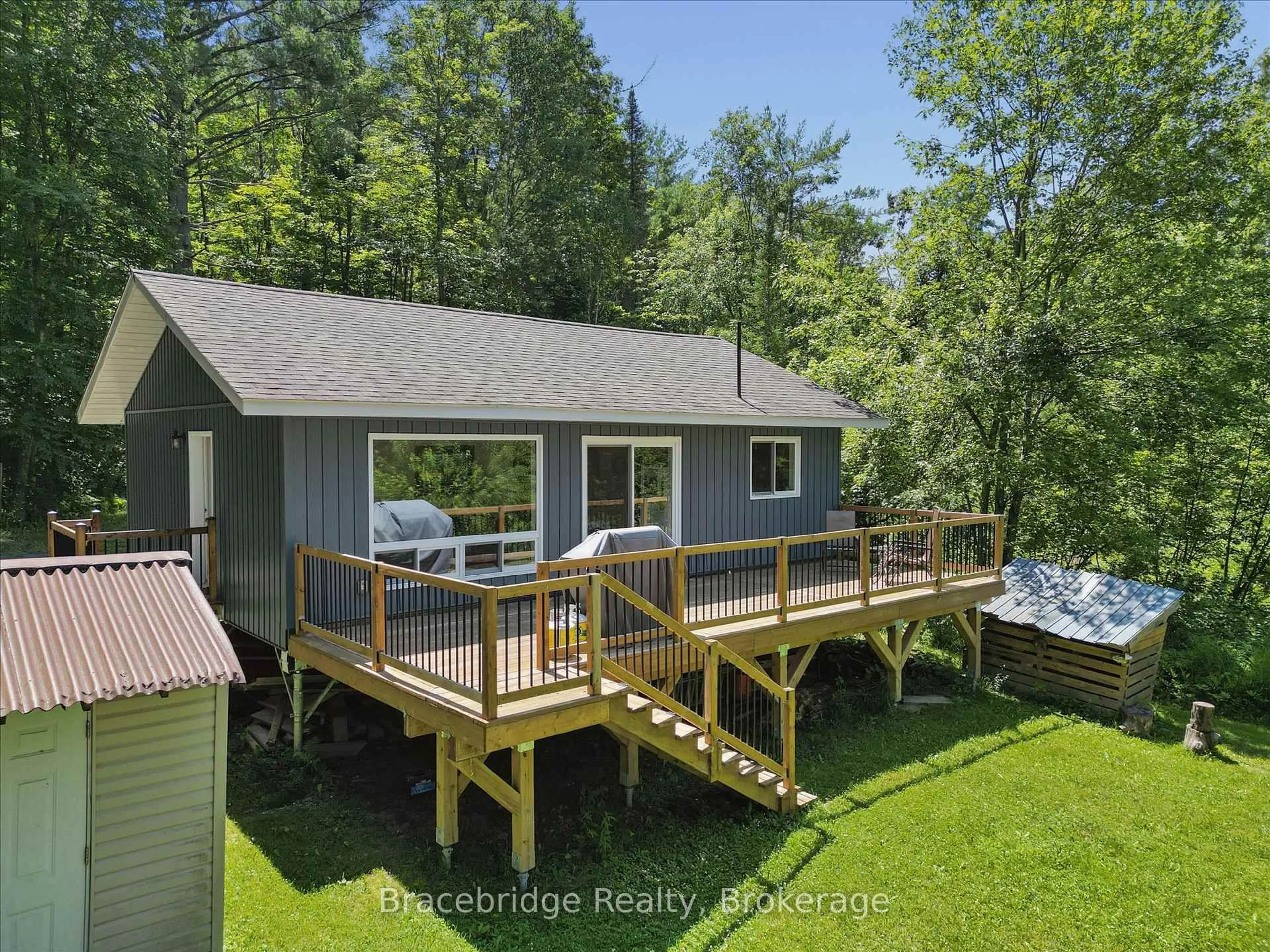 A pic from outside/outdoor area/front of a property/back of a property/a pic from drone, water/lake/river/ocean view for 1106 River Haven Rd, Bracebridge Ontario P1L 1X1