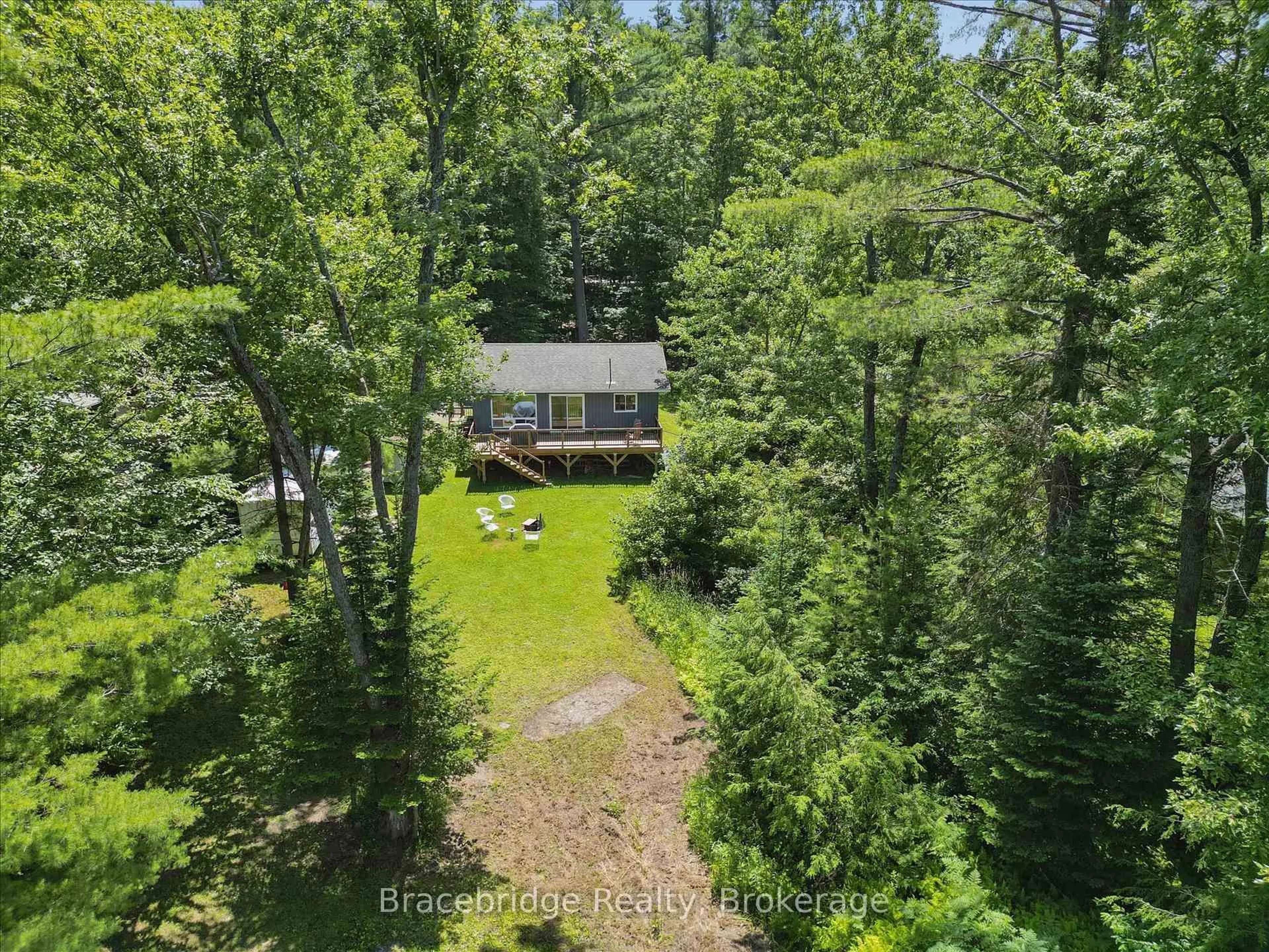 A pic from outside/outdoor area/front of a property/back of a property/a pic from drone, forest/trees view for 1106 River Haven Rd, Bracebridge Ontario P1L 1X1