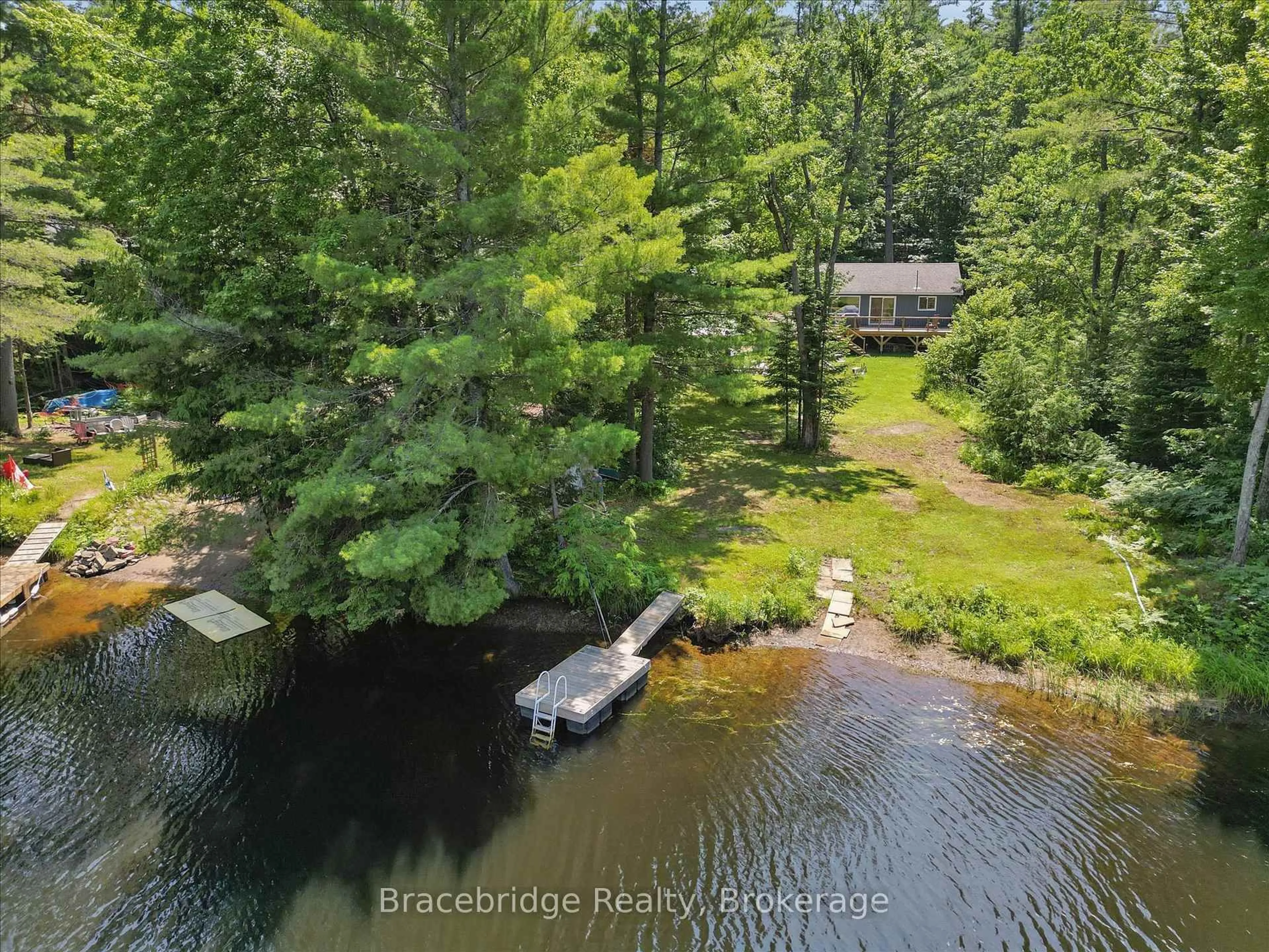 A pic from outside/outdoor area/front of a property/back of a property/a pic from drone, water/lake/river/ocean view for 1106 River Haven Rd, Bracebridge Ontario P1L 1X1
