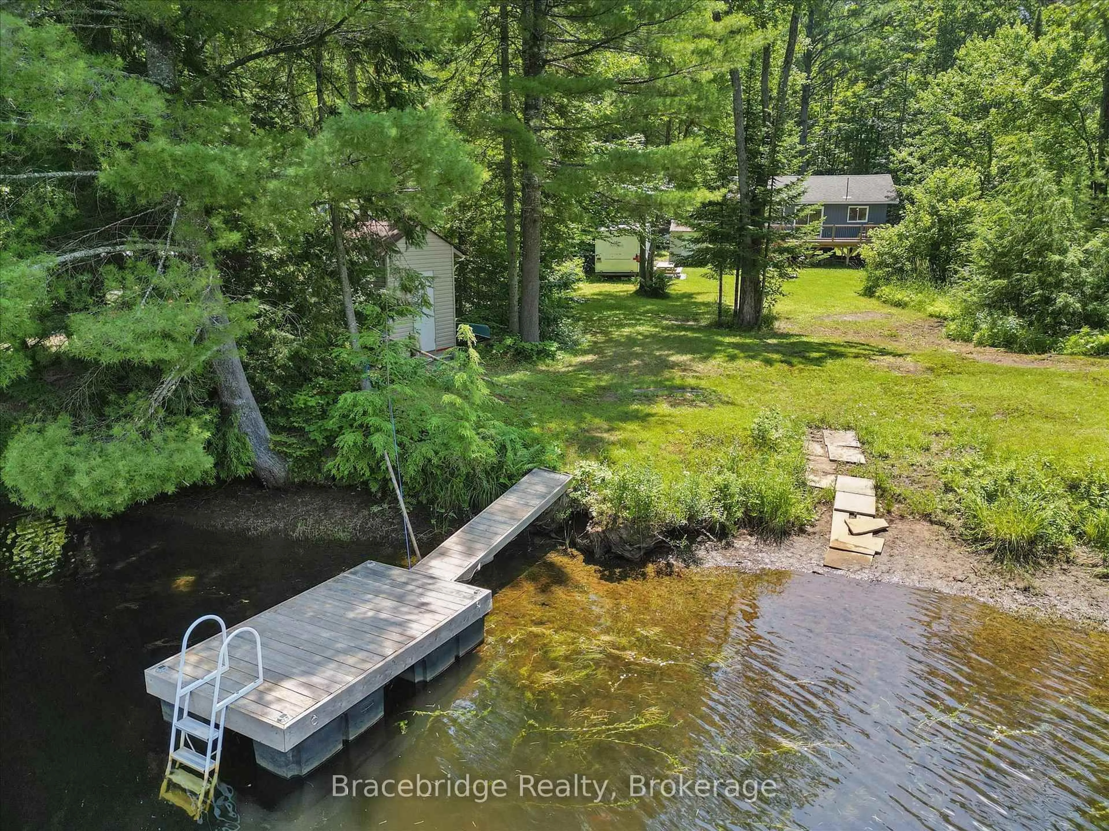 A pic from outside/outdoor area/front of a property/back of a property/a pic from drone, water/lake/river/ocean view for 1106 River Haven Rd, Bracebridge Ontario P1L 1X1