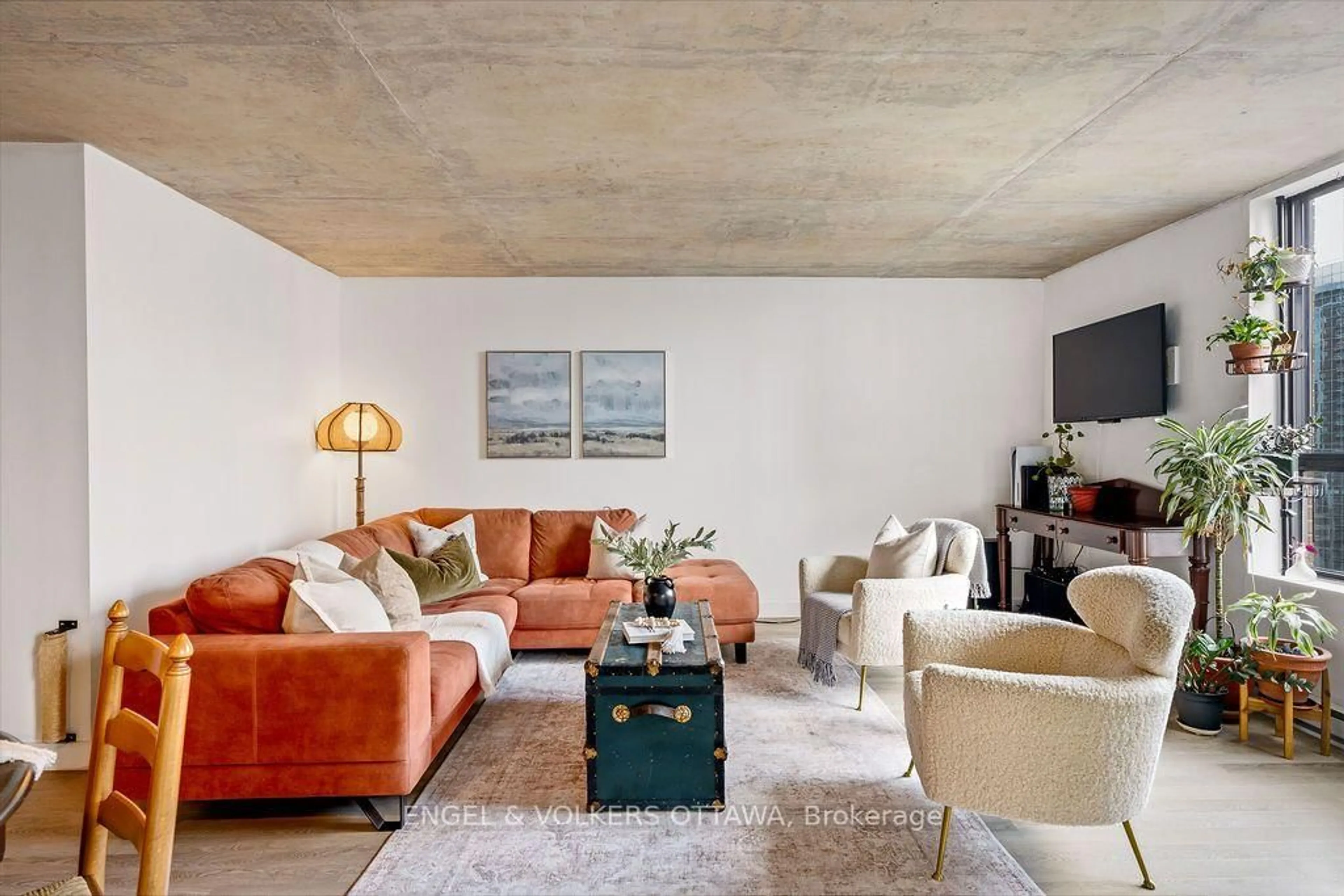 Living room with furniture, cement floor for 475 Laurier Ave #1602, Ottawa Ontario K1R 7X1